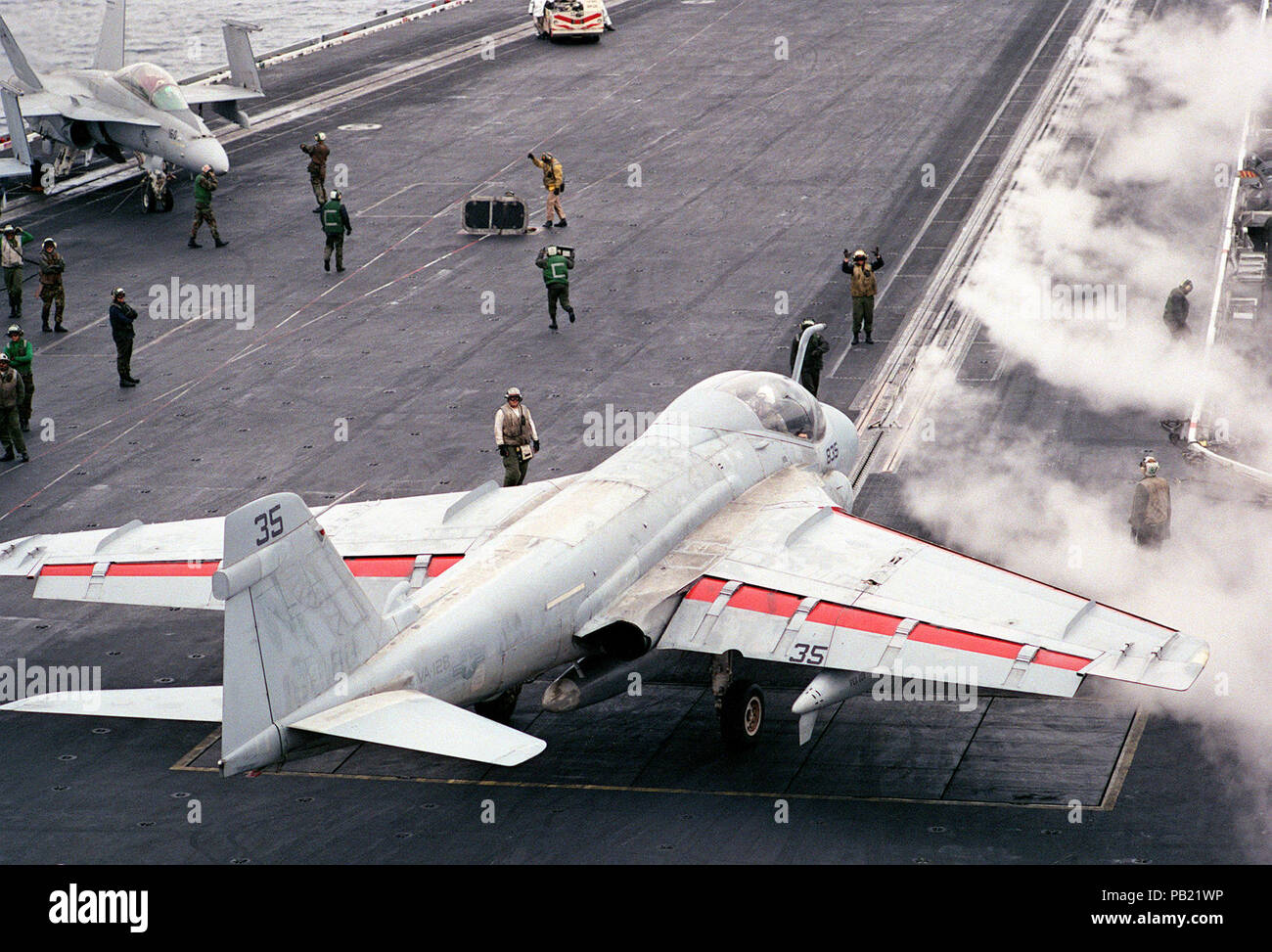 A-6E VA-128 on USS Ranger (CV-61) 1992. An Attack Squadron 128 (VA-128) A-6E Intruder aircraft lines up on a catapult for launch as steam clears from a previous launch on the flight deck of the aircraft carrier USS RANGER (CV-61). Stock Photo