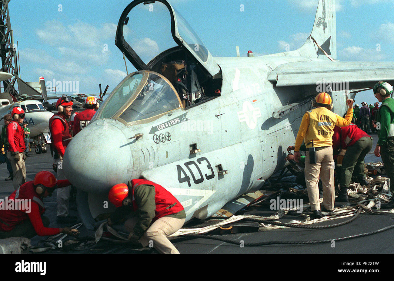 A-7E VA-72 barricade crash on USS Kennedy (CV-67) 1991. Flight deck personnel work to secure an A-7E Corsair II aircraft after an emergency barricade landing on the aircraft carrier USS JOHN F. KENNEDY (CV-67).  The Attack Squadron 72 (VA-72) aircraft was returning from a mission over Iraq during Operation Desert Storm when a problem with the nose gear was detected. Stock Photo