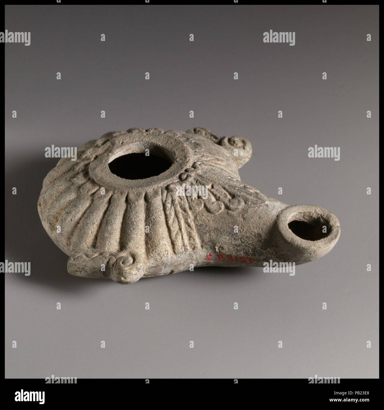 Terrracotta oil lamp. Culture: Greek. Dimensions: Overall: 1 1/8 x 3 3/4 in. (2.9 x 9.5 cm). Museum: Metropolitan Museum of Art, New York, USA. Stock Photo