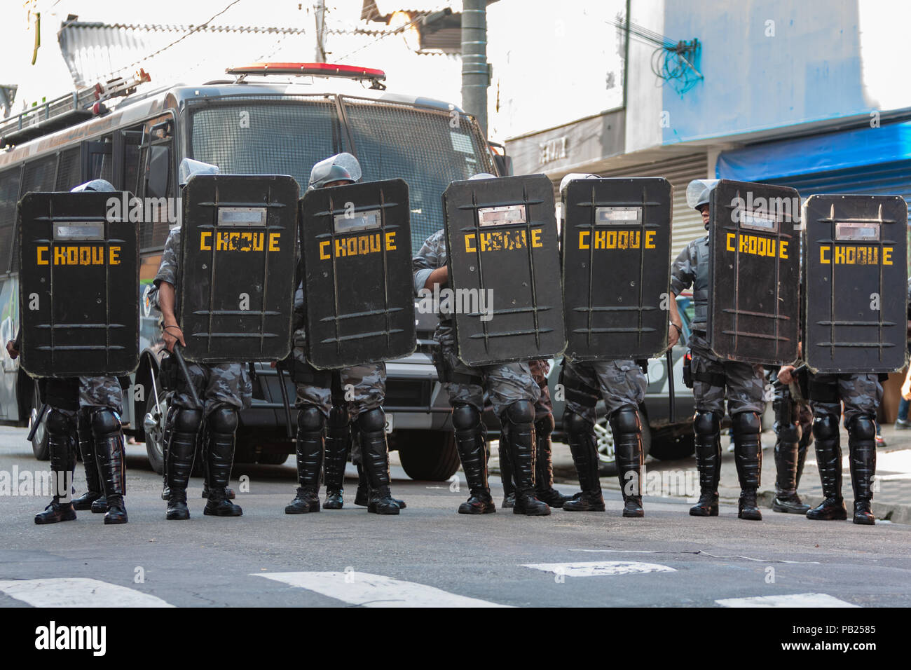 Riot police hold up shields as they form up during a protest by street ...