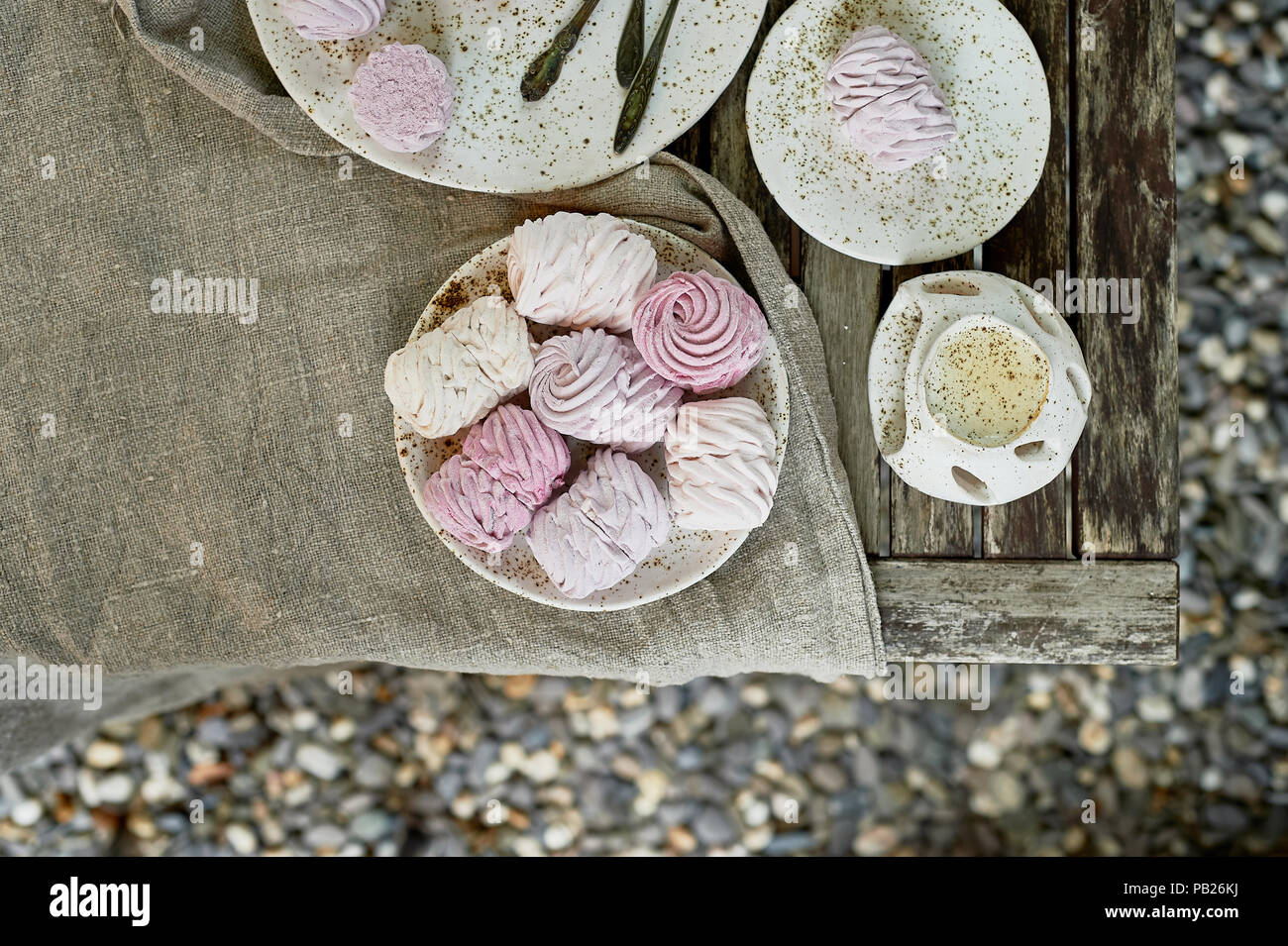 Summer tea in the fresh air.On plates prepared marshmallows and ... Summer tea in the fresh air.On plates prepared marshmallows and ...
