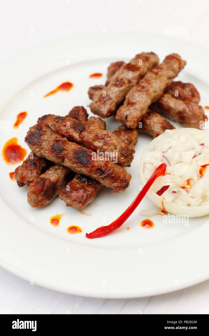 chevap or kebab grilled meat sticks with chopped onions and pepper