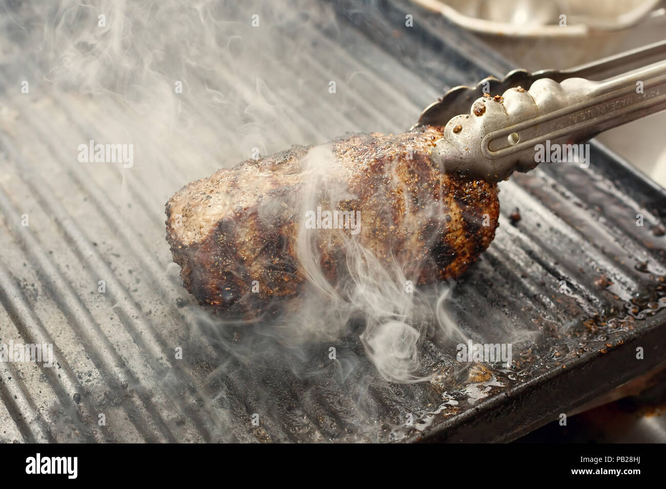 smoking beef stake on a grill, horizontal Stock Photo