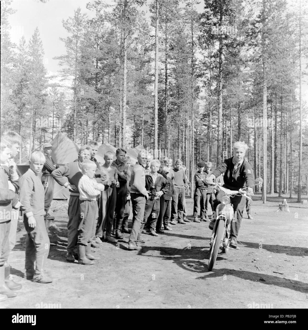 Male teenager riding a moped motorcycle watched by boys on a camping trip  in the countryside, Saarijärvi, Keski-Suomi, Finland 1959 Stock Photo -  Alamy
