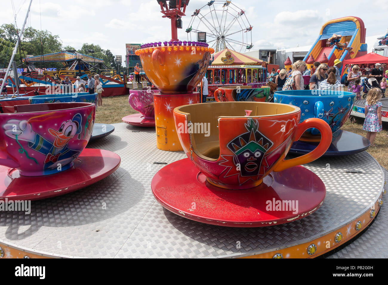 Colourful Cup and Saucer Roundabout Fairground Ride for Children on a Sunny Day at Nantwich Agricultural Show Cheshire England United Kingdom UK Stock Photo