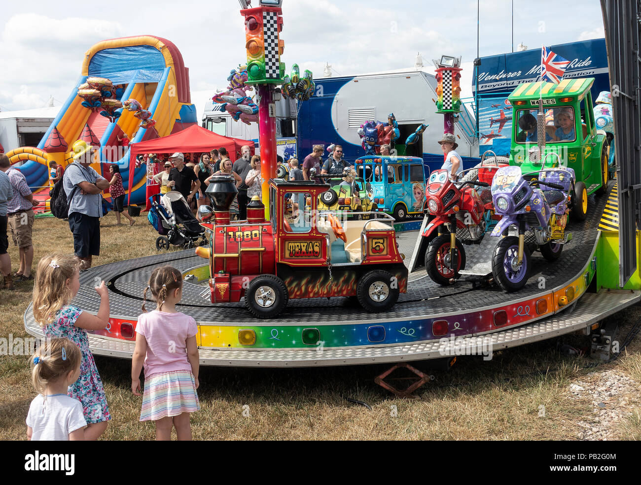 A Roundabout or Carousel for Child Rides on Train, Tractor, Motor Bikes, Bus and Car at Nantwich Agricultural Show Cheshire England United Kingdom UK Stock Photo