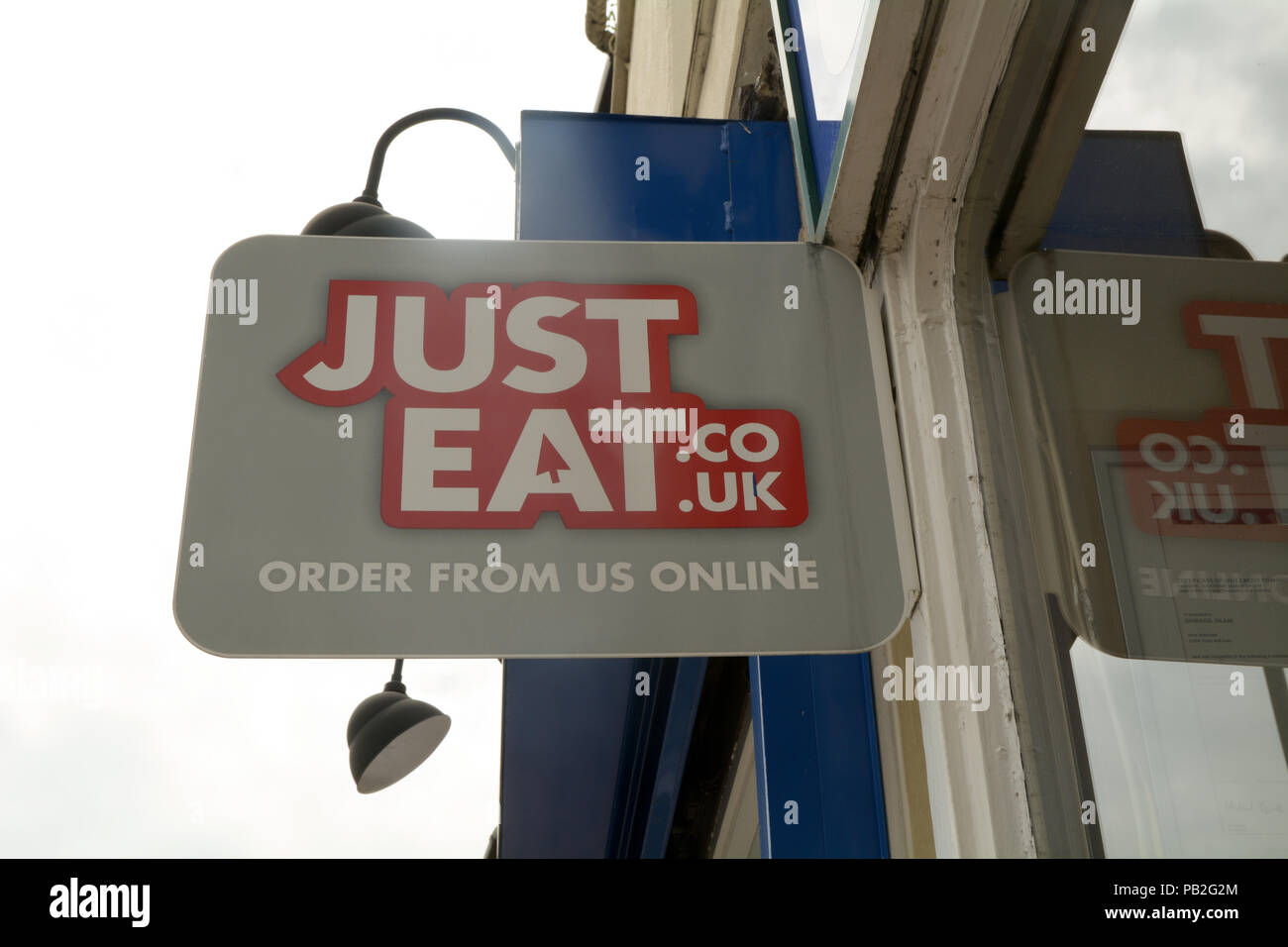 Just Eat sign outside fast food restaurant Stock Photo