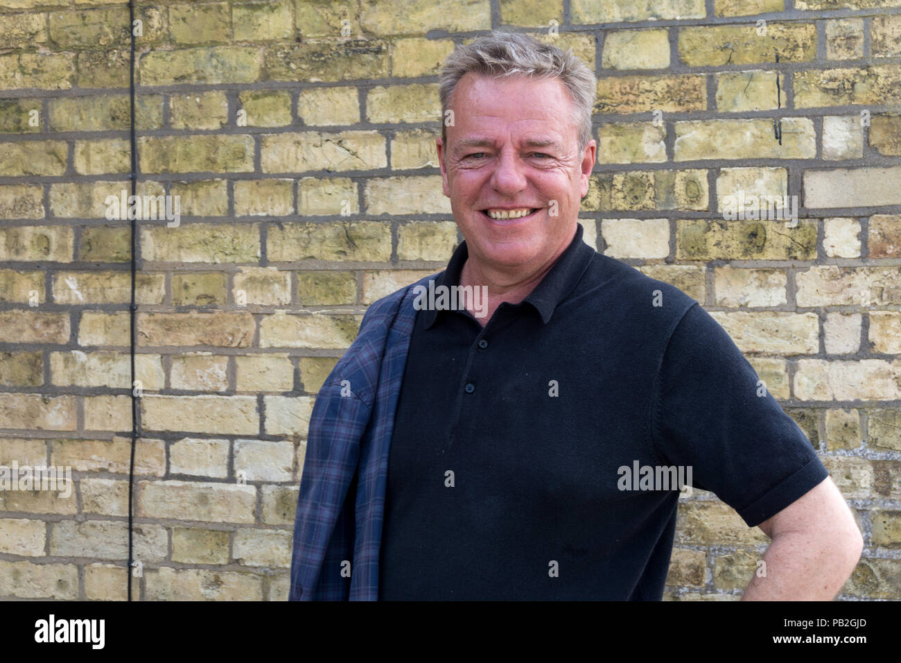 Suggs, the frontman for the pop group Madness, pictured during a break in filming at Weedon Depot near Northampton, UK Stock Photo