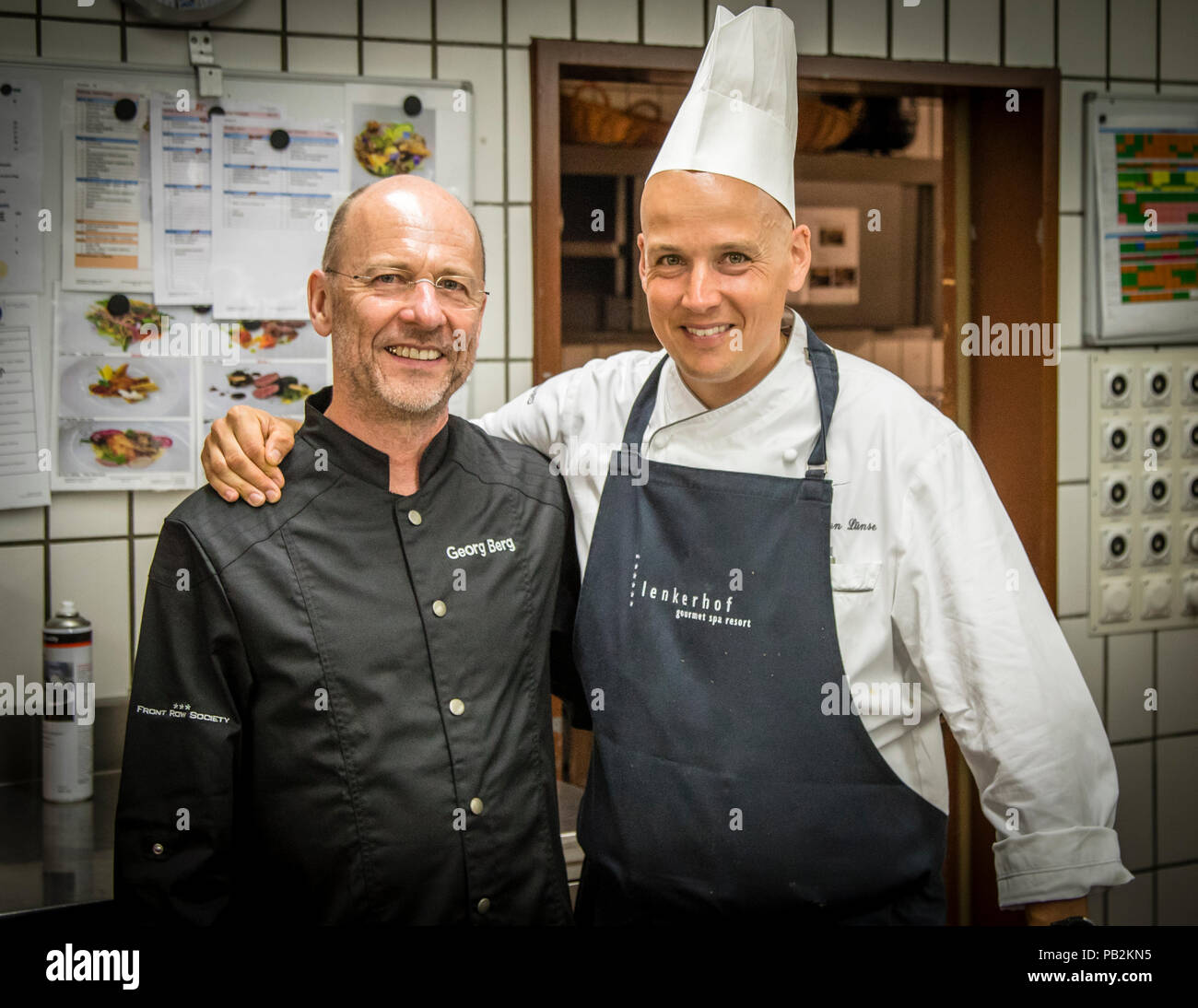 Chef Stefan Lünse of Hotel Lenkerhof poses with journalist Georg Berg in Lenk, Switzerland. Stock Photo