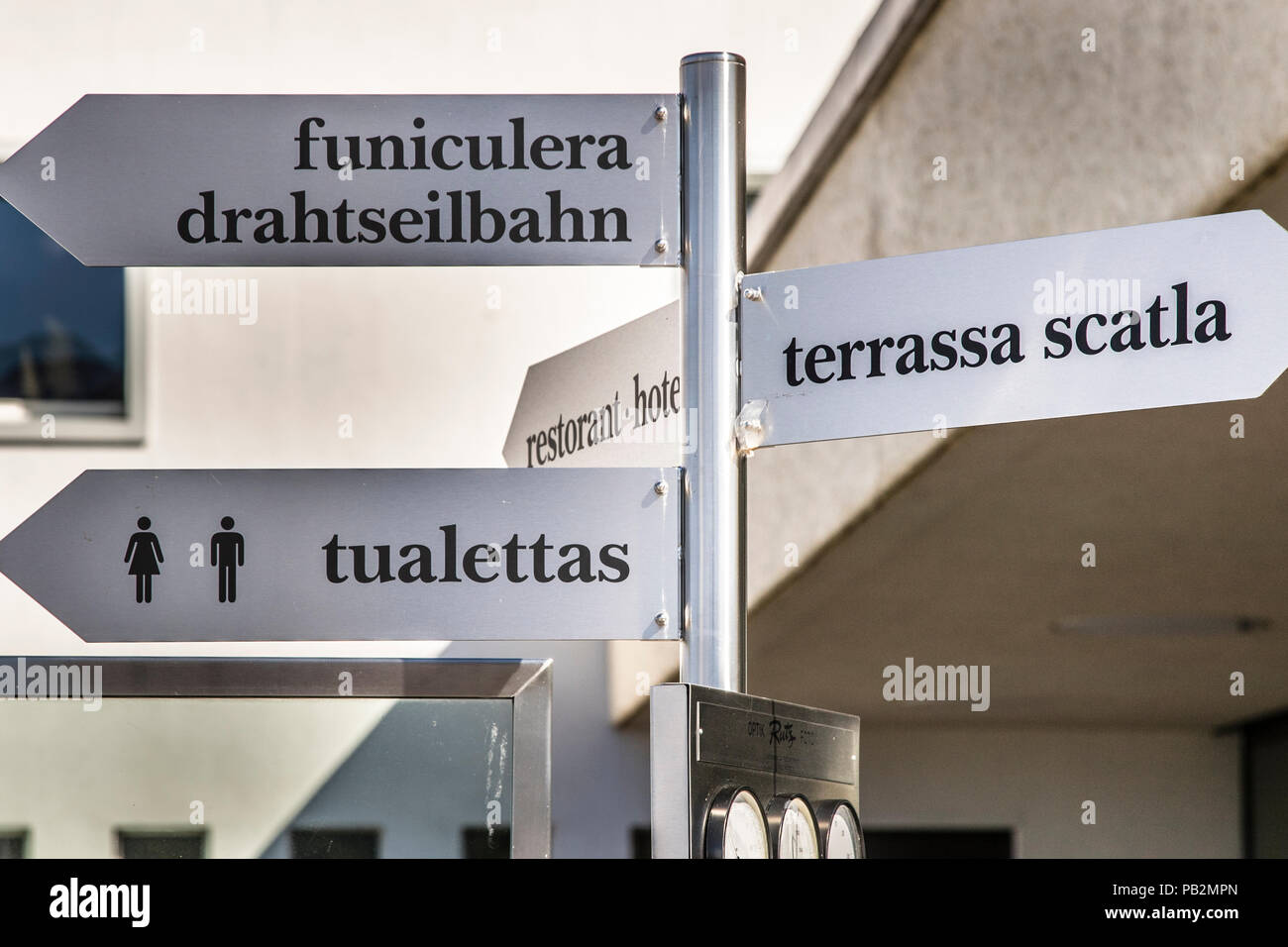 In Switzerland, Romansh, which is spoken by only a few people, is also an important language. Direction Signs in Rhaeto-Romanic Language on Top of Muottas Muragl, Switzerland Stock Photo