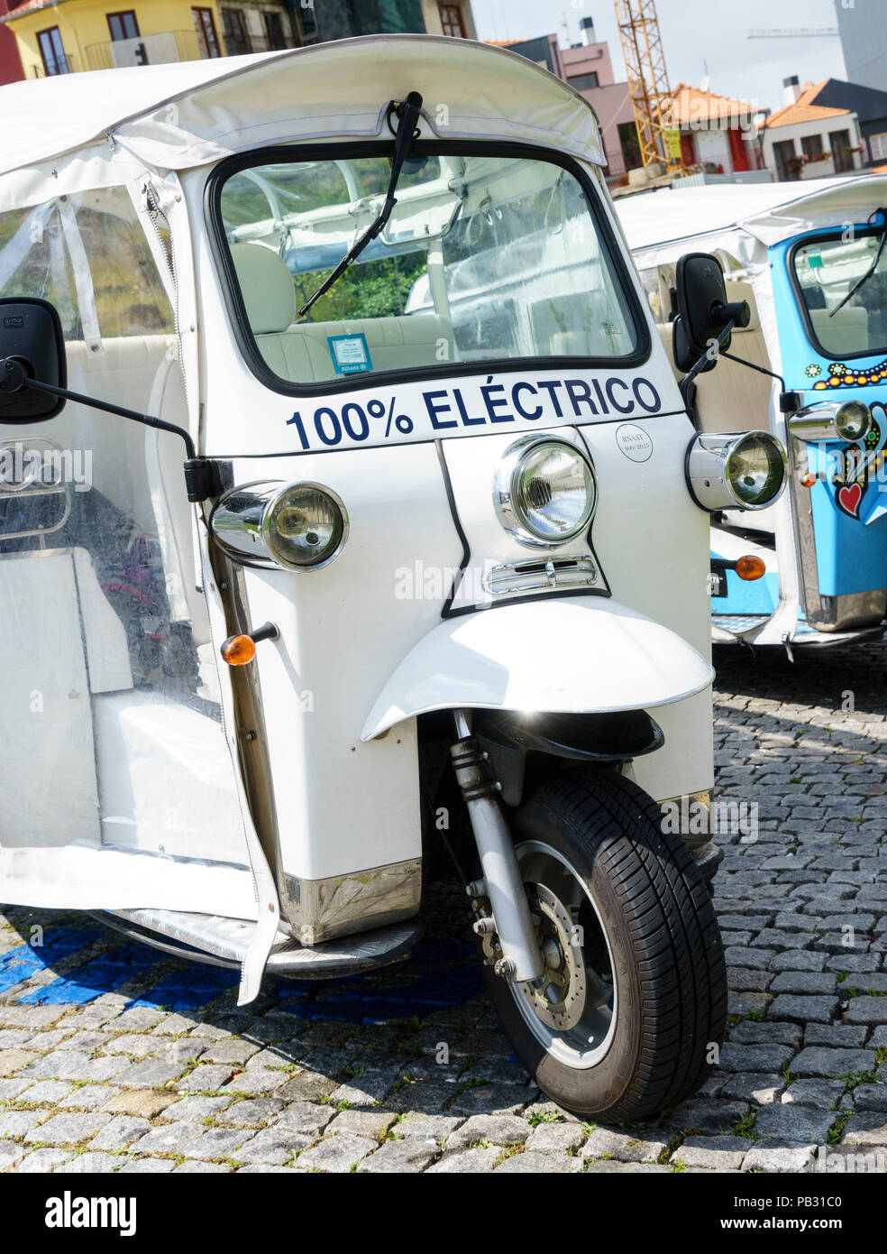 Closeup front view of a 100% electric tuktuk or three wheeled car in Porto Portugal Stock Photo