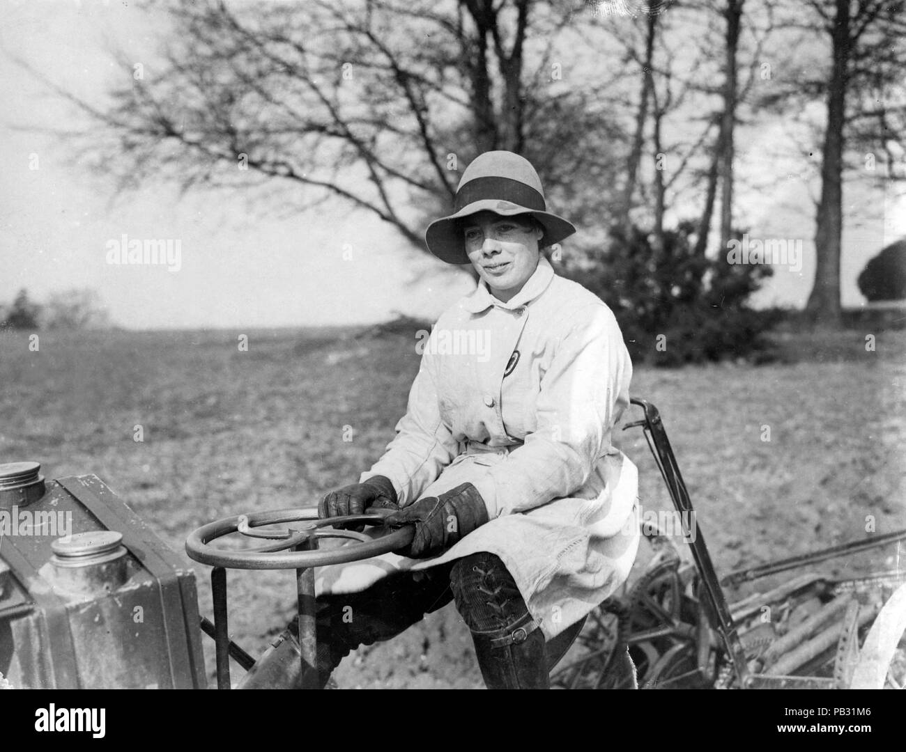 Official photograph showing female farmer driving a tractor Stock Photo