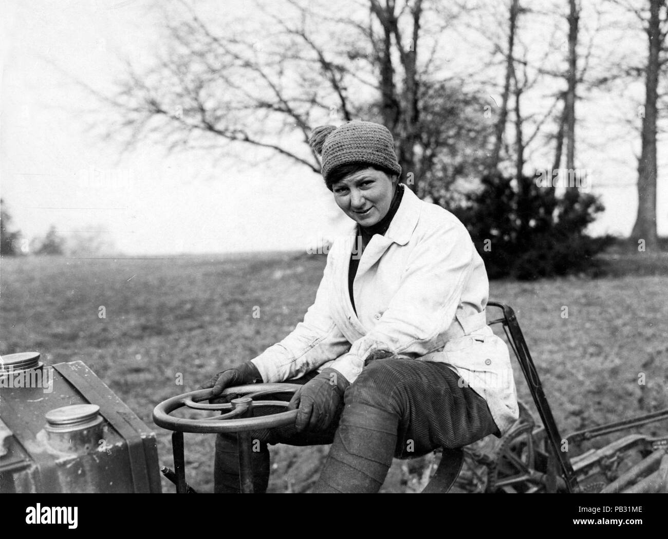 Official photograph showing female farmer driving a tractor Stock Photo