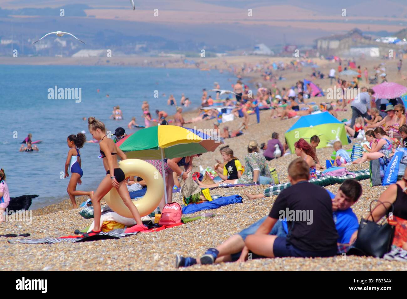 Seaford, East Sussex, UK. 26th July 2018. Temperatures already rising on Seaford Beach, East Sussex. © Peter Cripps/Alamy Live News Stock Photo