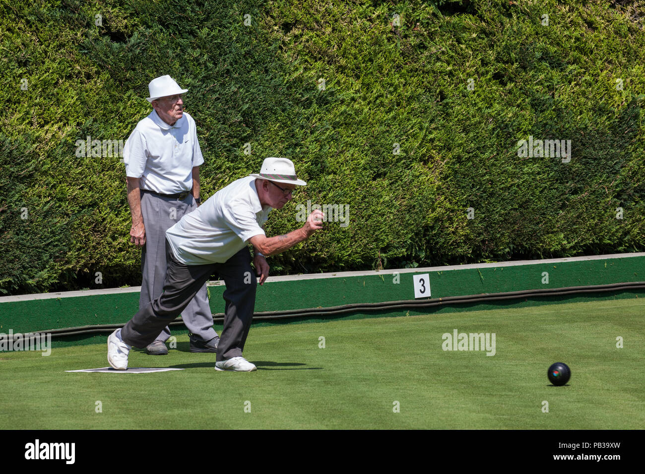 Windsor, UK. 26th July, 2018. Two men enjoy a game of bowls on a still pristine lawn at the Windsor and Eton Bowling Club on a very hot summer's day. Temperatures are expected to reach 36C today in the south-east. Even if imposed, sports facilities such as bowling clubs are often exempt from water restrictions during a drought. Credit: Mark Kerrison/Alamy Live News Stock Photo