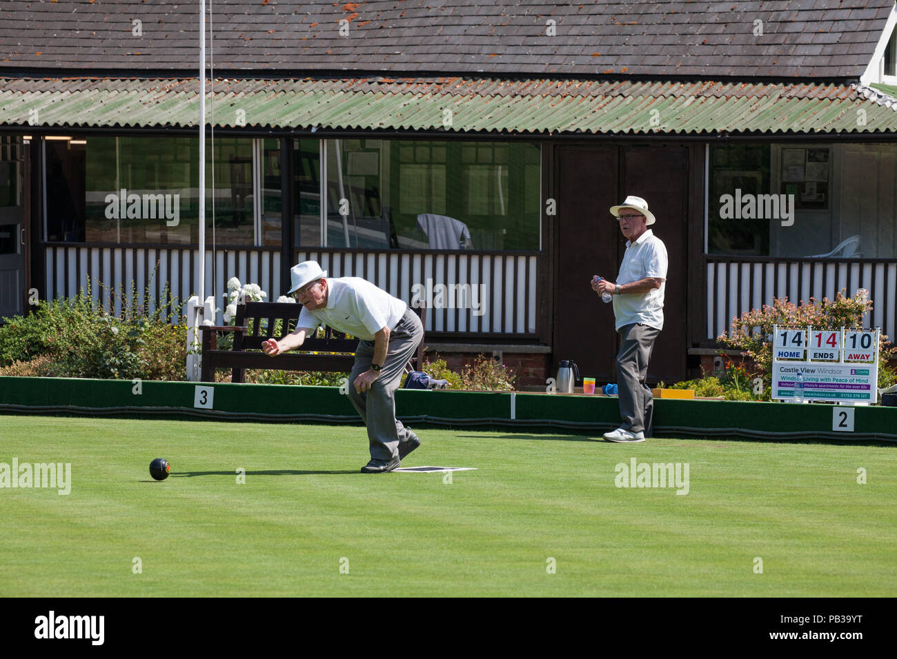 Windsor, UK. 26th July, 2018. Two men enjoy a game of bowls on a still pristine lawn at the Windsor and Eton Bowling Club on a very hot summer's day. Temperatures are expected to reach 36C today in the south-east. Even if imposed, sports facilities such as bowling clubs are often exempt from water restrictions during a drought. Credit: Mark Kerrison/Alamy Live News Stock Photo