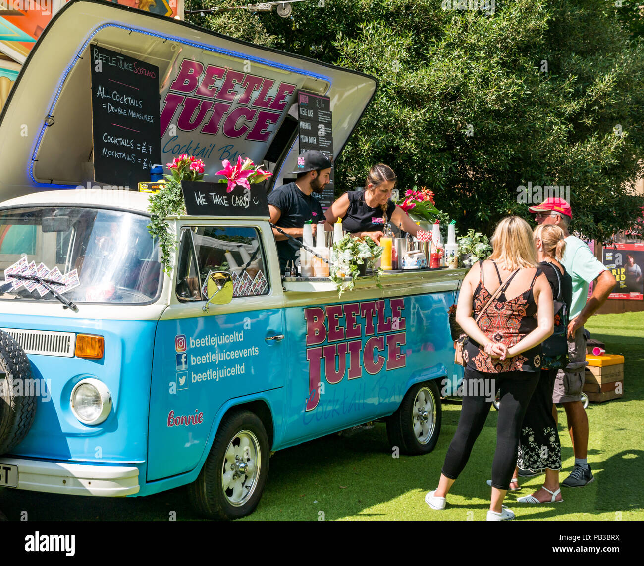 Edinburgh, UK. 26th July 2018. Edinburgh Food Festival 2018 in George Square Gardens, Edinburgh, Scotland, United Kingdom. There are food stalls with over 20 local food and drink producers in the free outdoor event. Customers at the Beetle Juice cocktail camper van bar Stock Photo