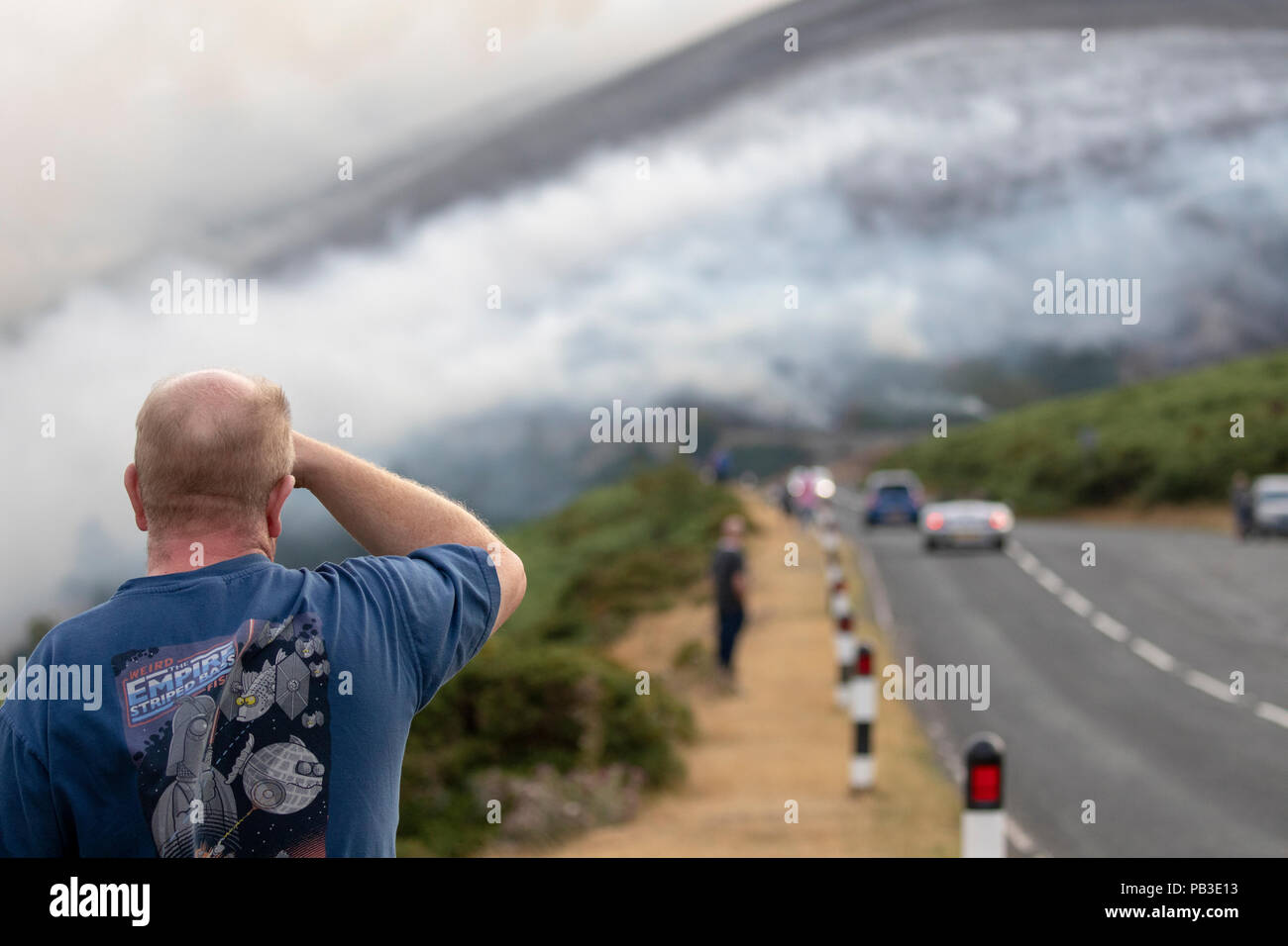 Public spectators watching the moorland fire at Llantysilio Mountain along the Horseshoe Pass, Llangollen as the fire burns over the mountain due to heatwave temperatures in the UK Stock Photo