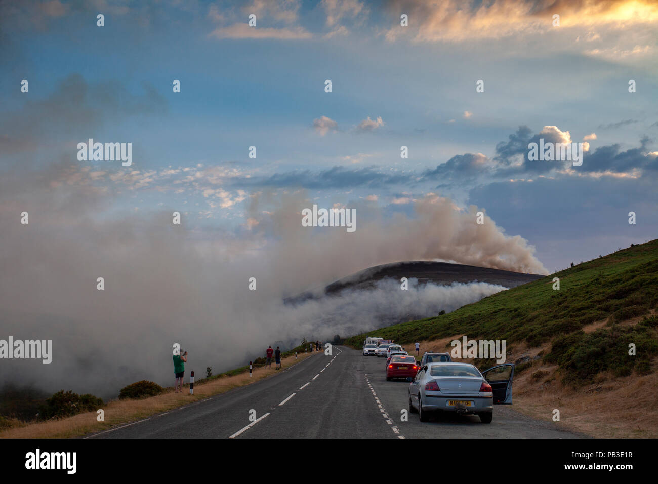 Public spectators watching the moorland fire at Llantysilio Mountain along the Horseshoe Pass, Corwen near Llangollen as the fire burns over the mountain due to heatwave temperatures in the UK Stock Photo