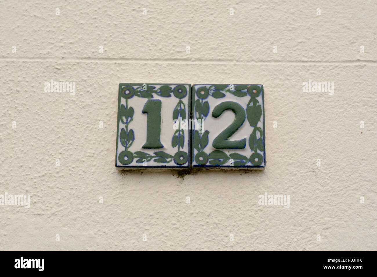 House number 12 sign on wall Stock Photo