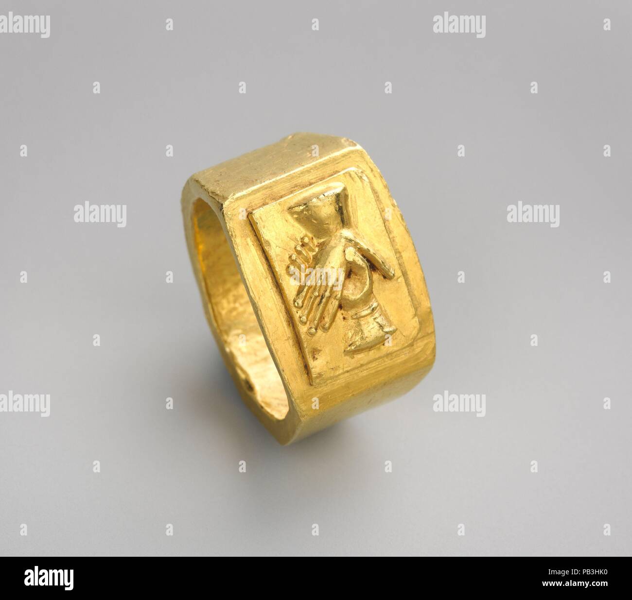 Gold finger ring. Culture: Roman. Dimensions: 1/2 × 3/4 in., 0.499oz. (1.3 × 1.9 cm, 14.15g)  Other (Bezel): 7/16 × 5/16 in. (1.2 × 0.8 cm). Date: 3rd century A.D..  This impressive ring was used as a betrothal or wedding band--a tradition that only became firmly established in the third century A.D. The small size of the hoop suggests that it was given to a young fiancée or bride, but its weight implies that the couple was able to afford valuable pieces of gold jewelry. Museum: Metropolitan Museum of Art, New York, USA. Stock Photo