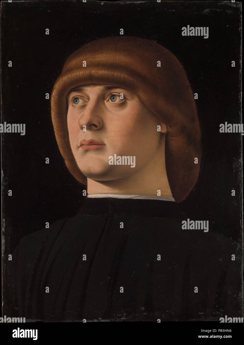 Portrait of a Young Man. Artist: Jacometto (Jacometto Veneziano) (Italian, active Venice by ca. 1472-died before 1498). Dimensions: 11 x 8 1/4 in. (27.9 x 21 cm). Date: 1480s.  A brilliant miniature painter, Jacometto was also outstanding at portraits. He was much influenced by the Sicilian painter Antonello da Messina, who worked in Venice in 1475-76, but Jacometto's portraits have a crystalline clarity, enhanced by the black background. The distinctive hairstyle--a zazzera--was fashionable in Venice in the 1480s and 90s. Museum: Metropolitan Museum of Art, New York, USA. Stock Photo