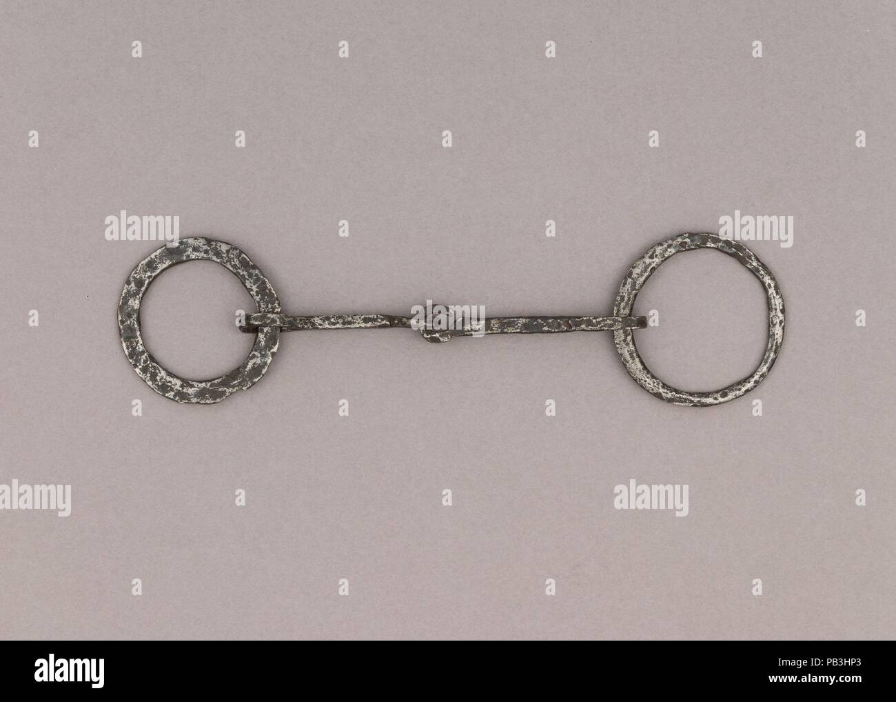 Snaffle Bit. Culture: German. Dimensions: W. 9 3/8 in. (23.8 cm); Wt. 3 oz. (85 g). Date: 9th-11th century.  If the Vikings are mostly known for being talented sailors, one may forget they were also horse riders, and as in all the Germanic cultures, horses had great importance in their society, in both its social and religious aspects. Equestrian equipment, like stirrups, spurs and bits, are regularly found in Viking burials, among the goods warriors wanted to bring with them to the afterlife. The elite would sometimes even be accompanied by sacrificed horses, a meaningful practice at that tim Stock Photo