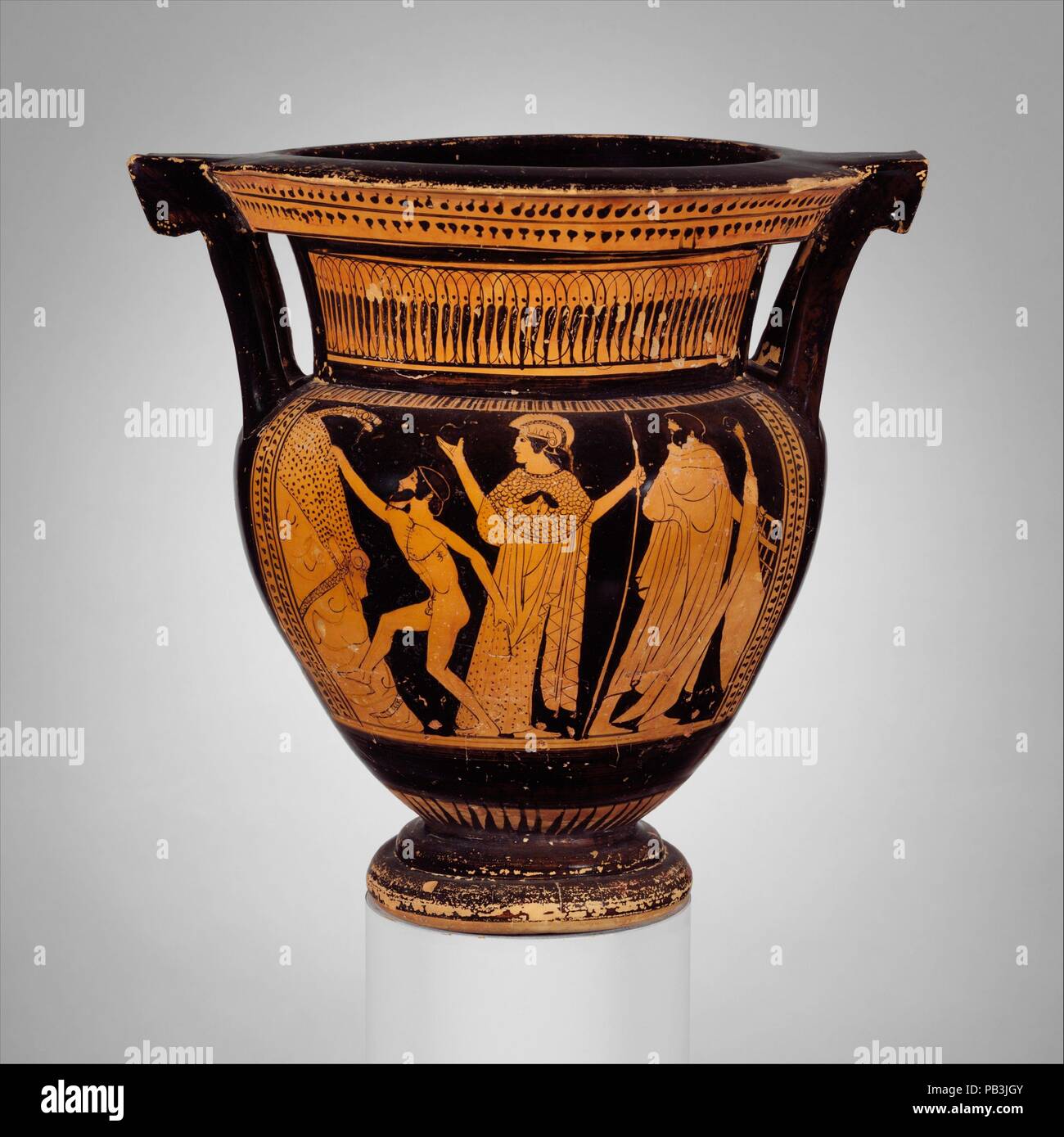 Terracotta column-krater (bowl for mixing wine and water). Culture: Greek, Attic. Dimensions: H. with handles  11 1/2 in. (29.2 cm). Date: ca. 470-460 B.C..  Obverse, Jason about to seize the Golden Fleece, the stern of the Argo at the right  Reverse, woman between two youths  Jason led the Argonauts, a band of adventurers who set out on the ship Argo to steal the magical golden fleece of a ram, which was preserved in Kolchis on the Black Sea.  With the help of the gods and the sorceress Medea, Jason was able to take the fleece from a grove protected by a dragon.  Here, with Athena beside him, Stock Photo