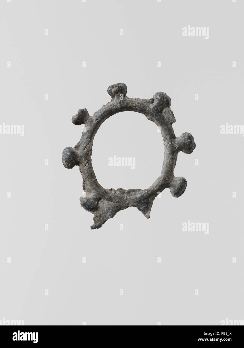 Lead wreath. Culture: Greek, Laconian. Dimensions: Diameter: 5/8 in. (1.7 cm). Date: 6th-5th century B.C..  Small flat votive figurines of cast lead have been found in great quantities at the ancient sanctuaries of Laconia; over one hundred thousand, dating from the seventh century B.C. to the Classical period, were dedicated to the goddess Artemis Orthia in Sparta. Museum: Metropolitan Museum of Art, New York, USA. Stock Photo