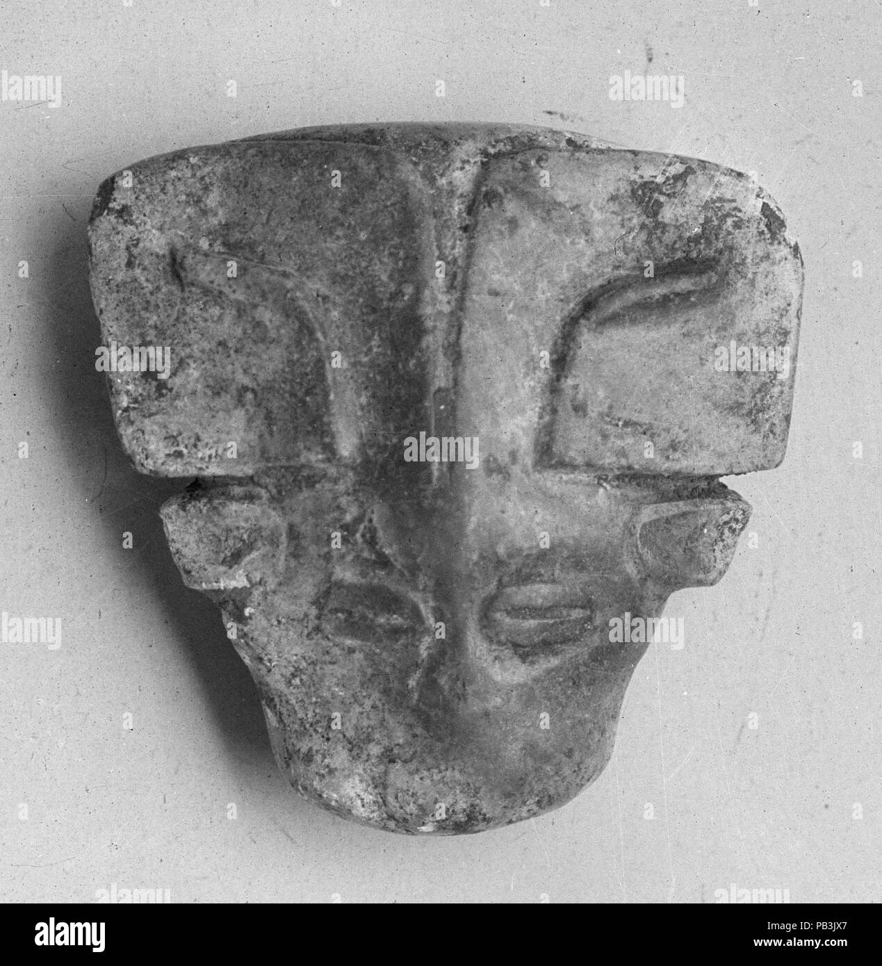 Plaque in the Shape of an Animal Head. Culture: China. Dimensions: H. 1 1/4 in. (3.2 cm); W. 1 1/4 in. (3.2 cm). Date: 11th-10th century B.C.. Museum: Metropolitan Museum of Art, New York, USA. Stock Photo