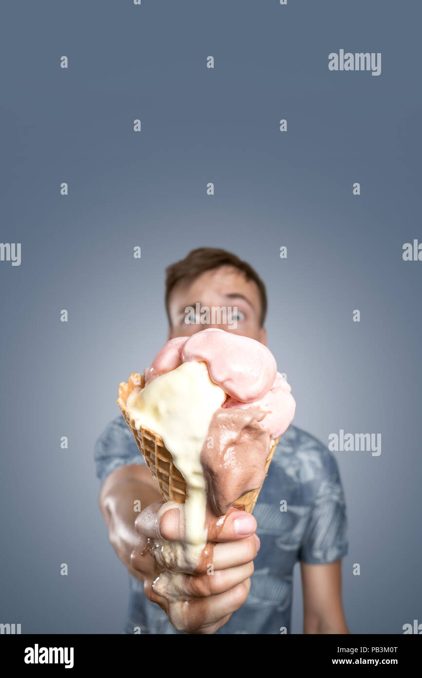 Man with a melting ice cream cone in his hand Stock Photo