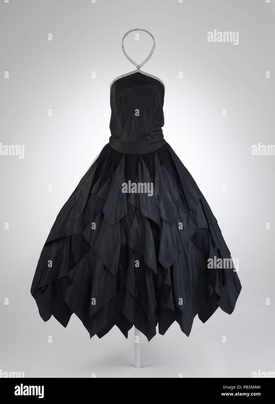 Traviata. Culture: French. Design House: House of Lanvin (French, founded 1889). Designer: Jeanne Lanvin (French, 1867-1946). Date: 1928.  In the early 1910s, Jeanne Lanvin began designing full-skirted gowns that would come to be known in the 1920s as robes de style. She considered the look--with its panniered form that evokes eighteenth-century elegance--feminine, romantic, and universally becoming. Turning to delicate fabrics for a more modern effect, Lanvin showed variations of the robe de style in her collections through the 1930s. Like eighteenth-century marchandes de modes, fashion merch Stock Photo