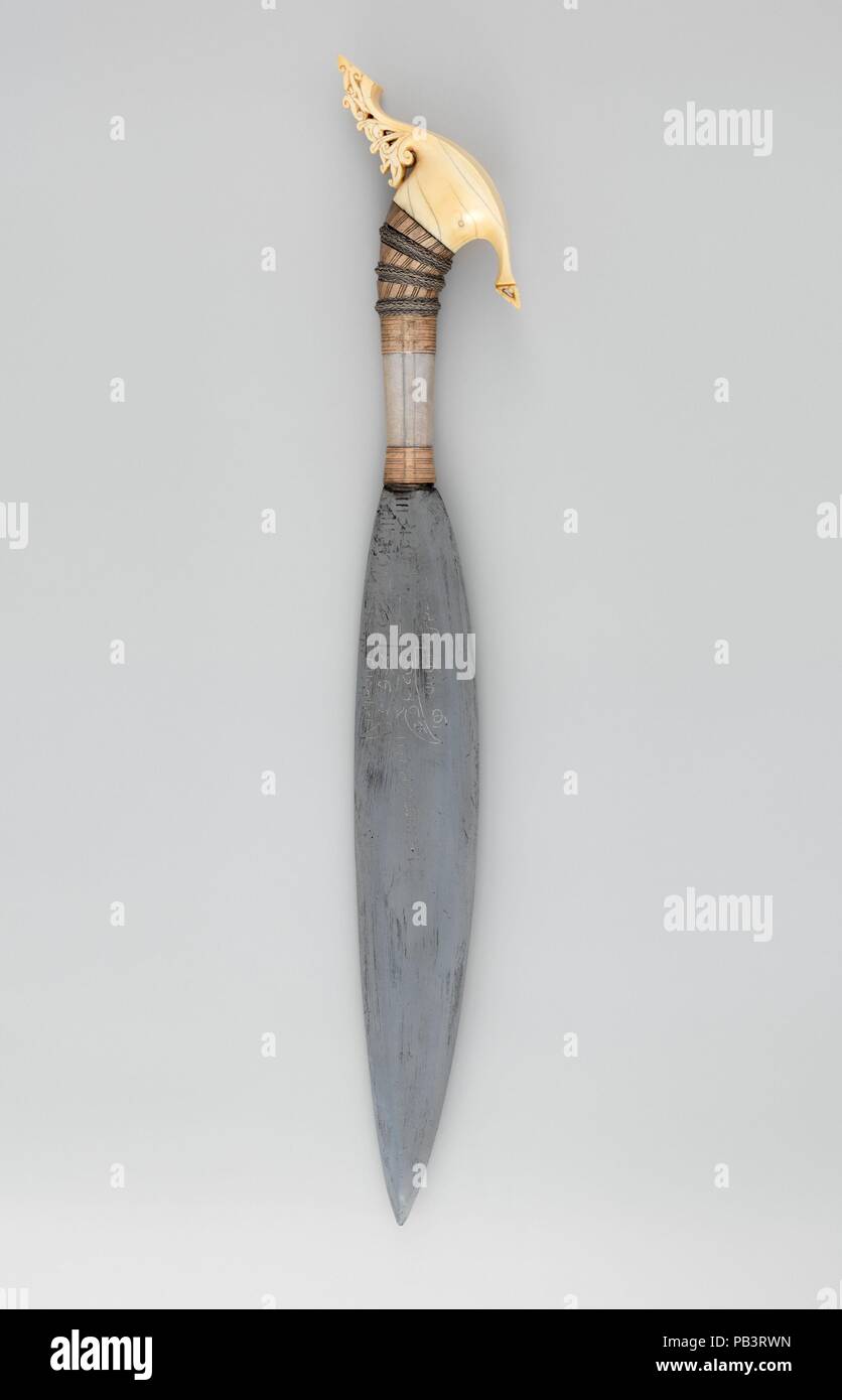 Knife (Barong) with Sheath. Culture: Philippine, Jolo Island or Zamboanga Peninsula. Dimensions: L. with sheath 28 in. (71.1 cm); L. without sheath 24 in. (61 cm); L. of blade 15 in. (38.1 cm); W. 3 5/8 in. (9.2 cm); Wt. 1 lb. 10.8 oz. (759.8 g); Wt. of sheath 7.9 oz. (224 g). Date: 19th century.  The barong is a knife distinct to the Muslim people of the southern Philippines. On both sides of this barong's blade is an image of <i>Dhu'l Fiqar</i> with the word 'Allah' inscribed in Arabic within its contours. The legendary sword is surrounded by Arabic letters and numbers, which are the result  Stock Photo