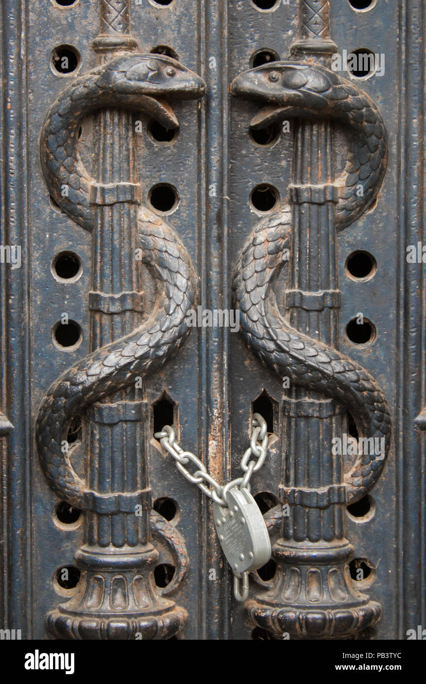 Snake decorated locked gates to a crypt in Brompton Cemetery, London, England, UK, Europe. Stock Photo