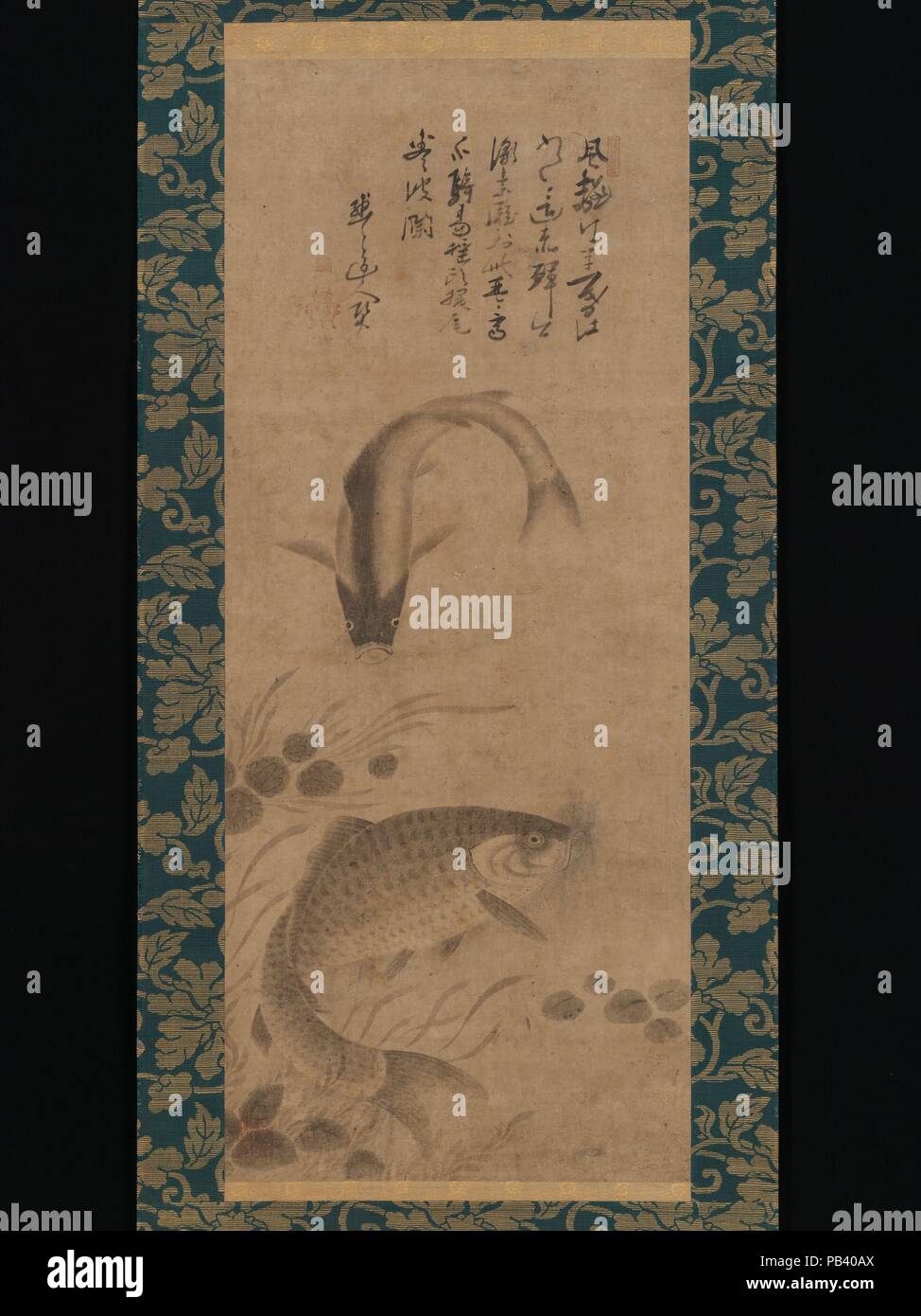 Carp and Waterweeds. Artist: Yogetsu (Japanese, active late 15th century); Inscribed by Mokumoku Dojin (Japanese, active late 15th century). Culture: Japan. Dimensions: Image: 33 7/16 × 13 7/8 in. (85 × 35.2 cm)  Overall with mounting: 65 3/4 × 19 1/16 in. (167 × 48.4 cm)  Overall with knobs: 65 3/4 × 20 7/8 in. (167 × 53 cm). Date: late 15th century.  Little is known about Yogetsu, who was active as a monk in the mountains northeast of the ancient capital of Nara. He is sometimes cited as a follower of the master painter Sesshu Toyo (1420-1506). Above Yogetsu's auspicious image of a pair of f Stock Photo