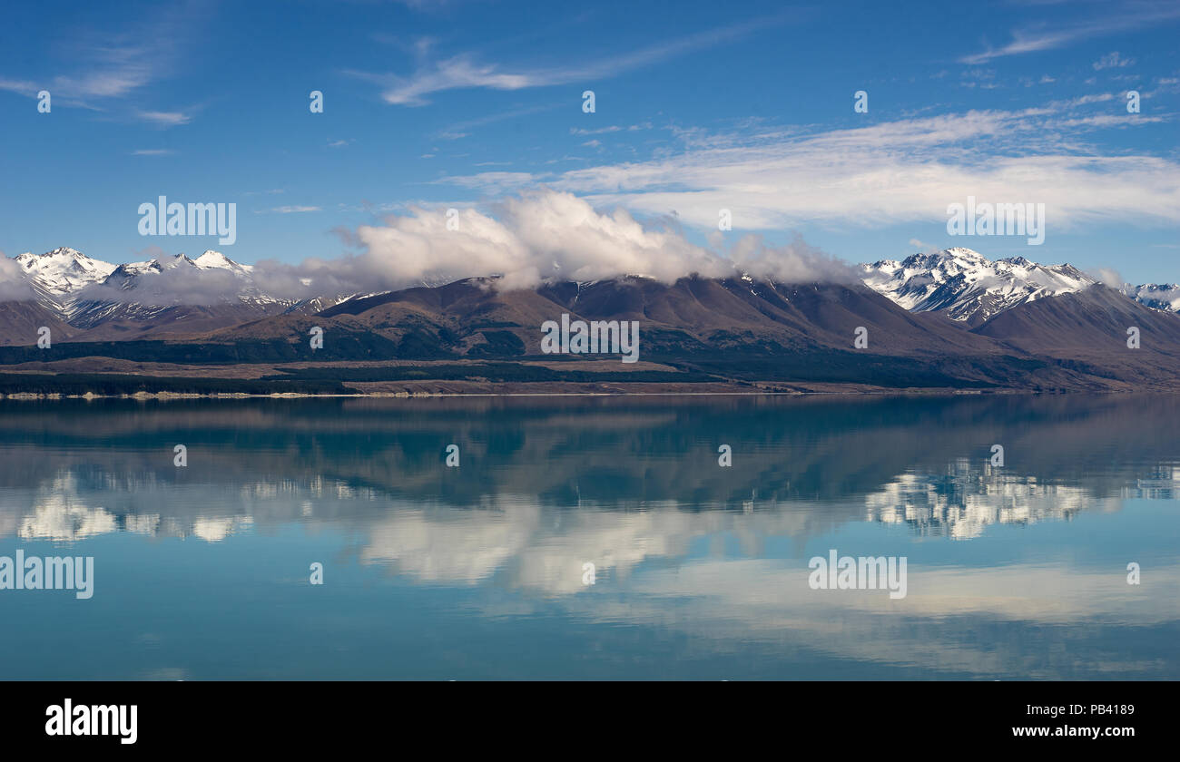 white cloud form and float on top of  mountain with blue sky reflect on turquoise lake Stock Photo