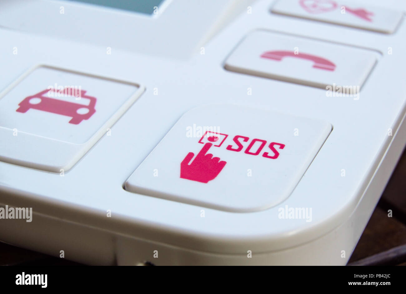 sos Red button on a dirty old panel, selective focus Stock Photo