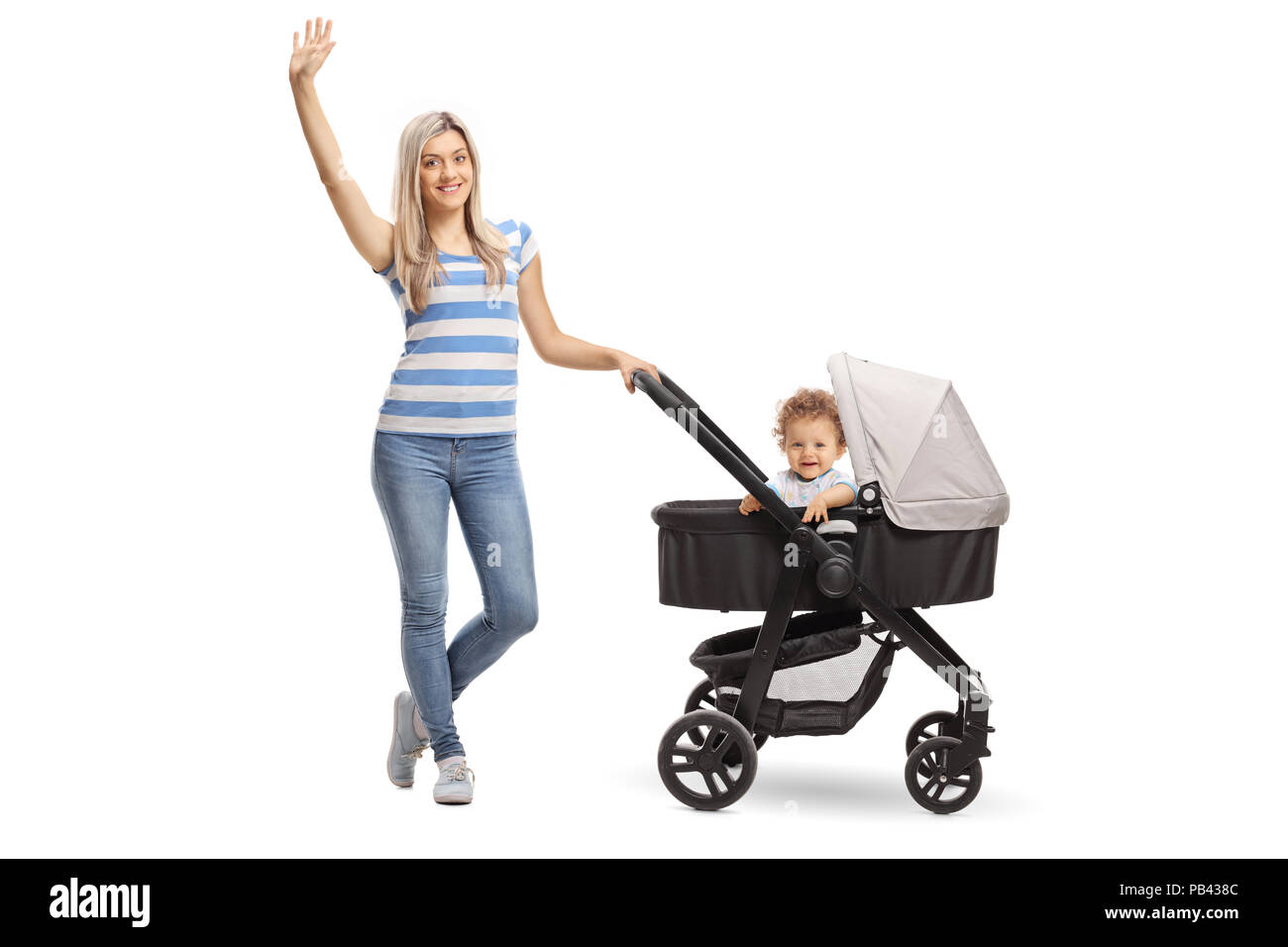 Full length portrait of a young mother with a baby boy in a stroller waving at the camera isolated on white background Stock Photo