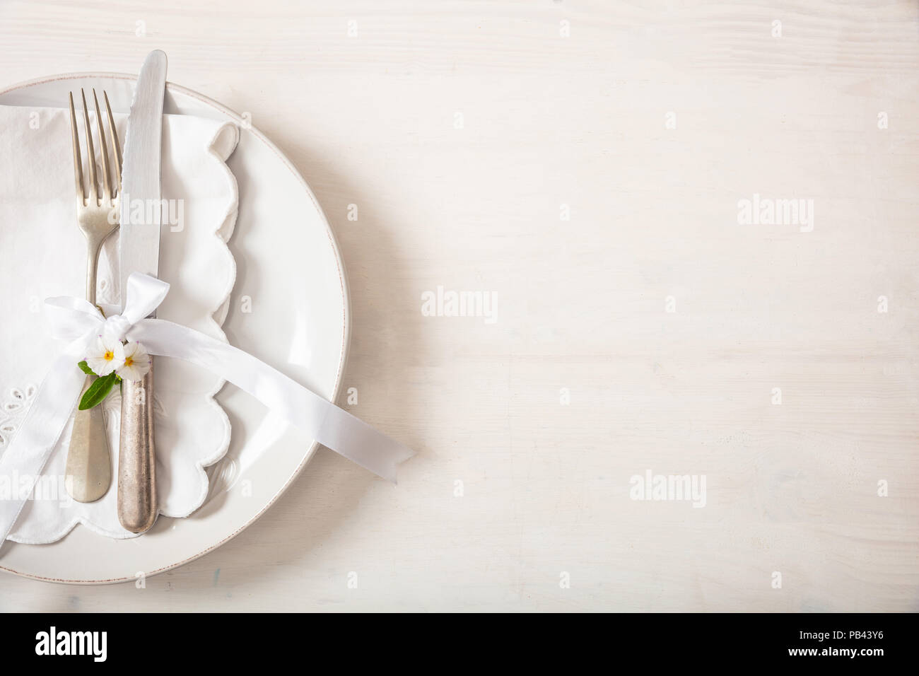 Holiday dinner. Table place setting with empty plates, silver fork and knife, copy space Stock Photo