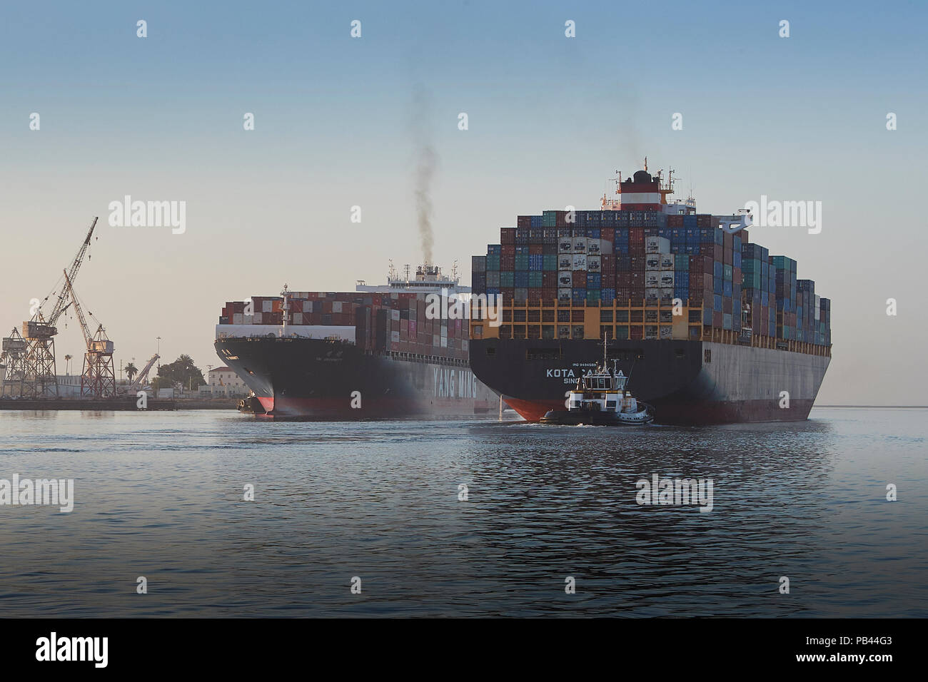 The Departing Container Ship KOTA CAHAYA, Passes Close To The Arriving YANG MING YM UNANIMITY In The Busy Los Angeles Main Channel, California, USA. Stock Photo