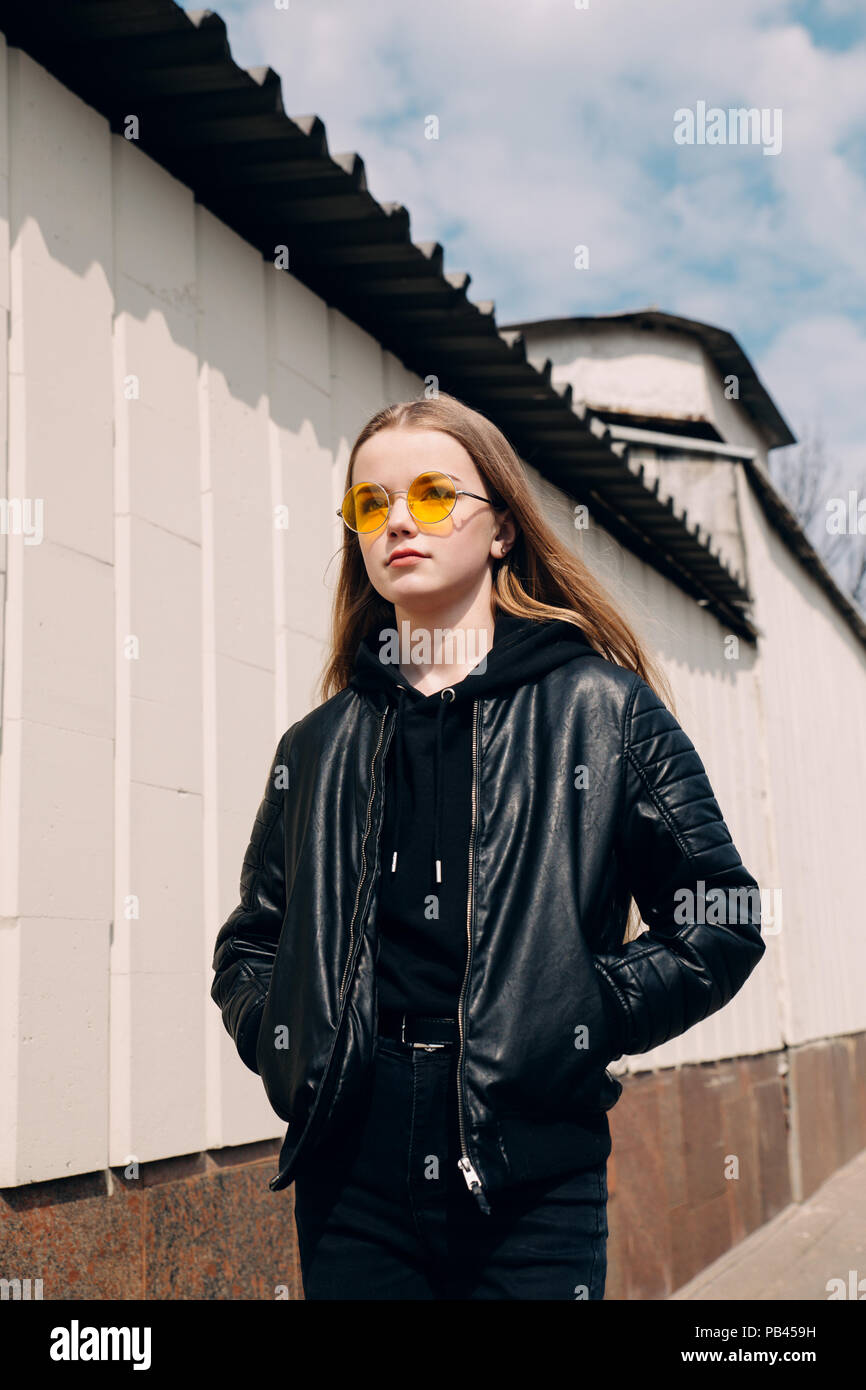 beautiful fashionable kid girl with long hair in yellow sunglasses in city, Street fashion kid, Stock Photo