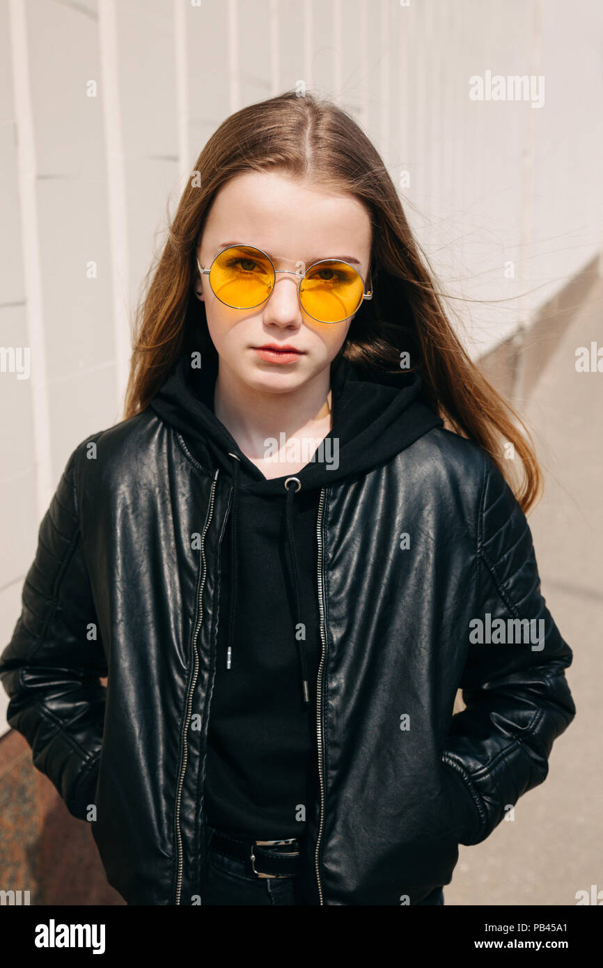 beautiful fashionable kid girl with long hair in yellow sunglasses in city,  Street fashion kid Stock Photo - Alamy