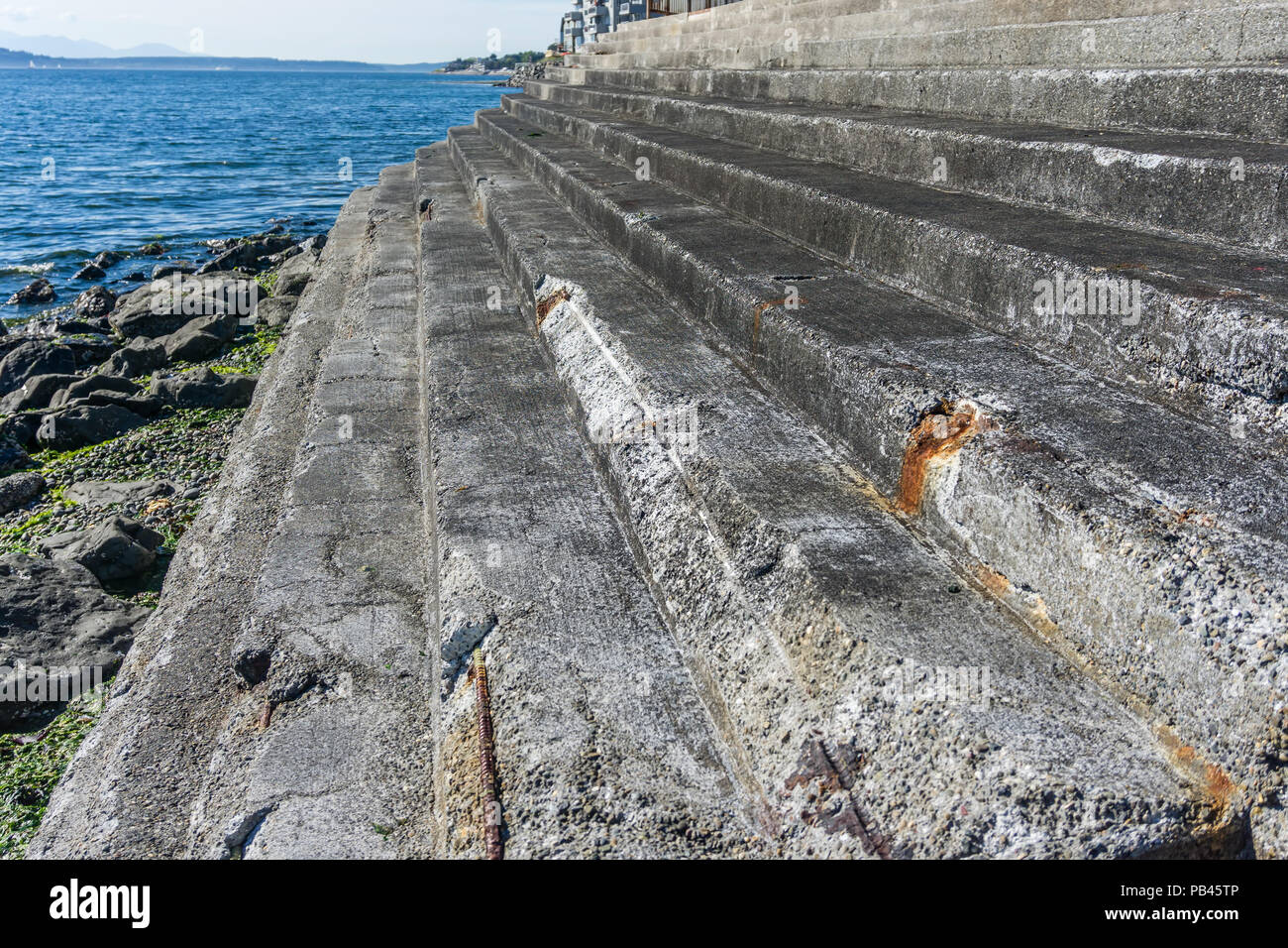 Cement steps lead to the sea in West Seattle, Washington. Stock Photo