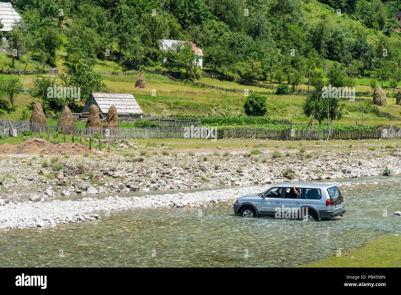 A car fording the river Grencars in Vermosh, the most northerly village in Albania, just below the border with Montinegro.  Albania. Stock Photo