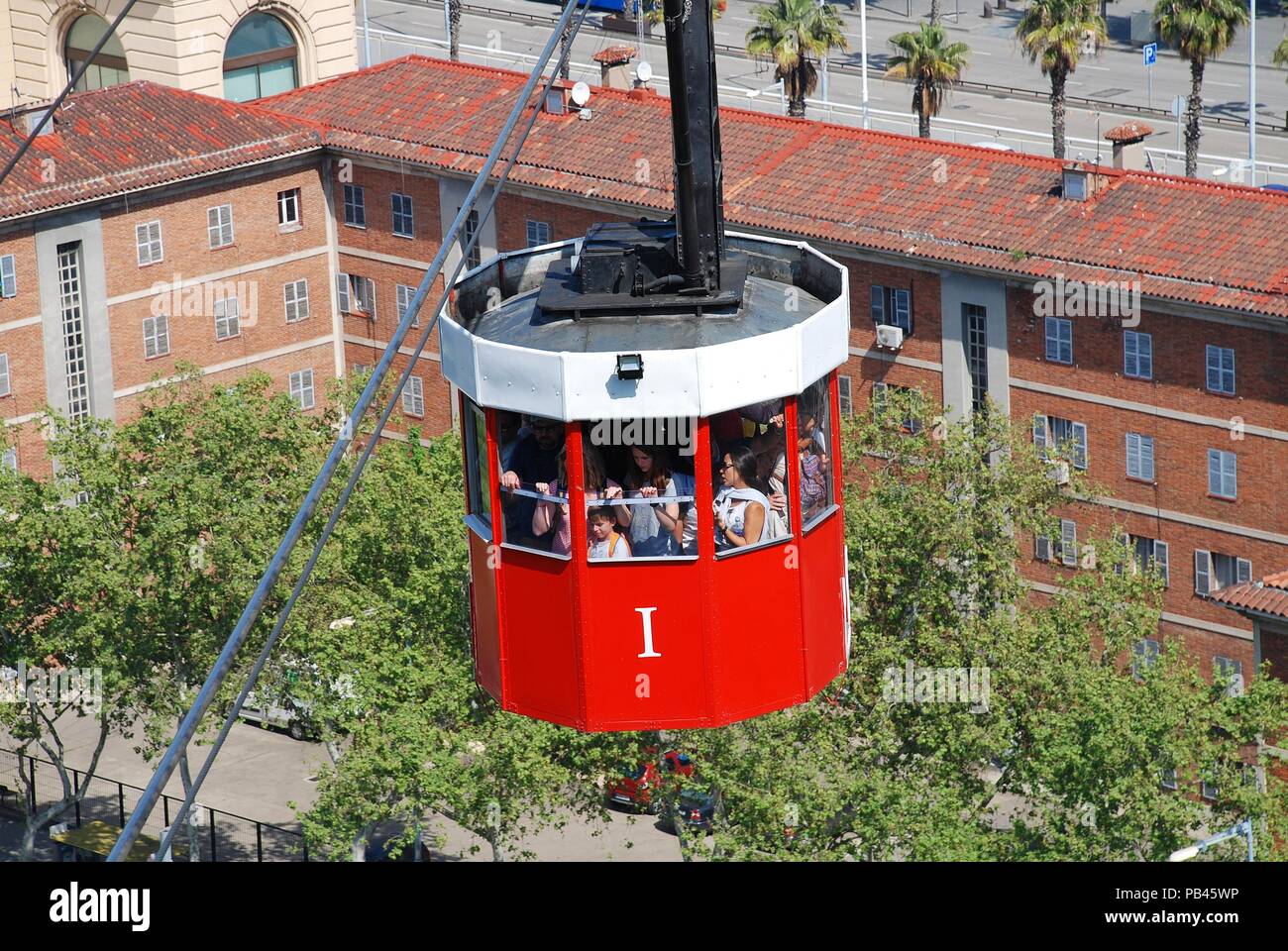 A vintage red cable car on the Transbordador Aeri del Port approaches Montjuic hill in Barcelona, Spain on April 19, 2018. Stock Photo