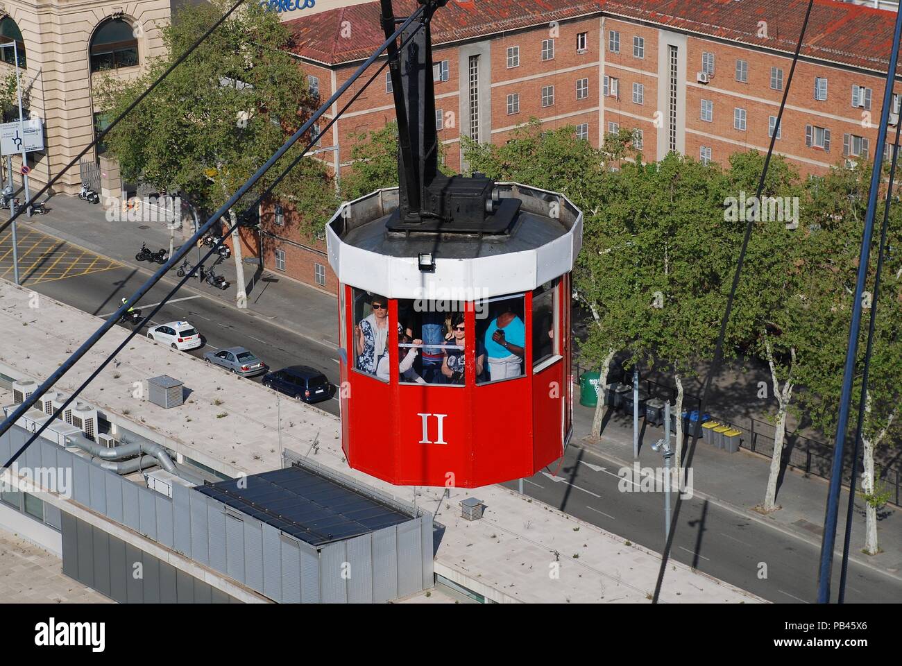 A vintage red cable car on the Transbordador Aeri del Port approaches Montjuic hill in Barcelona, Spain on April 19, 2018. Stock Photo