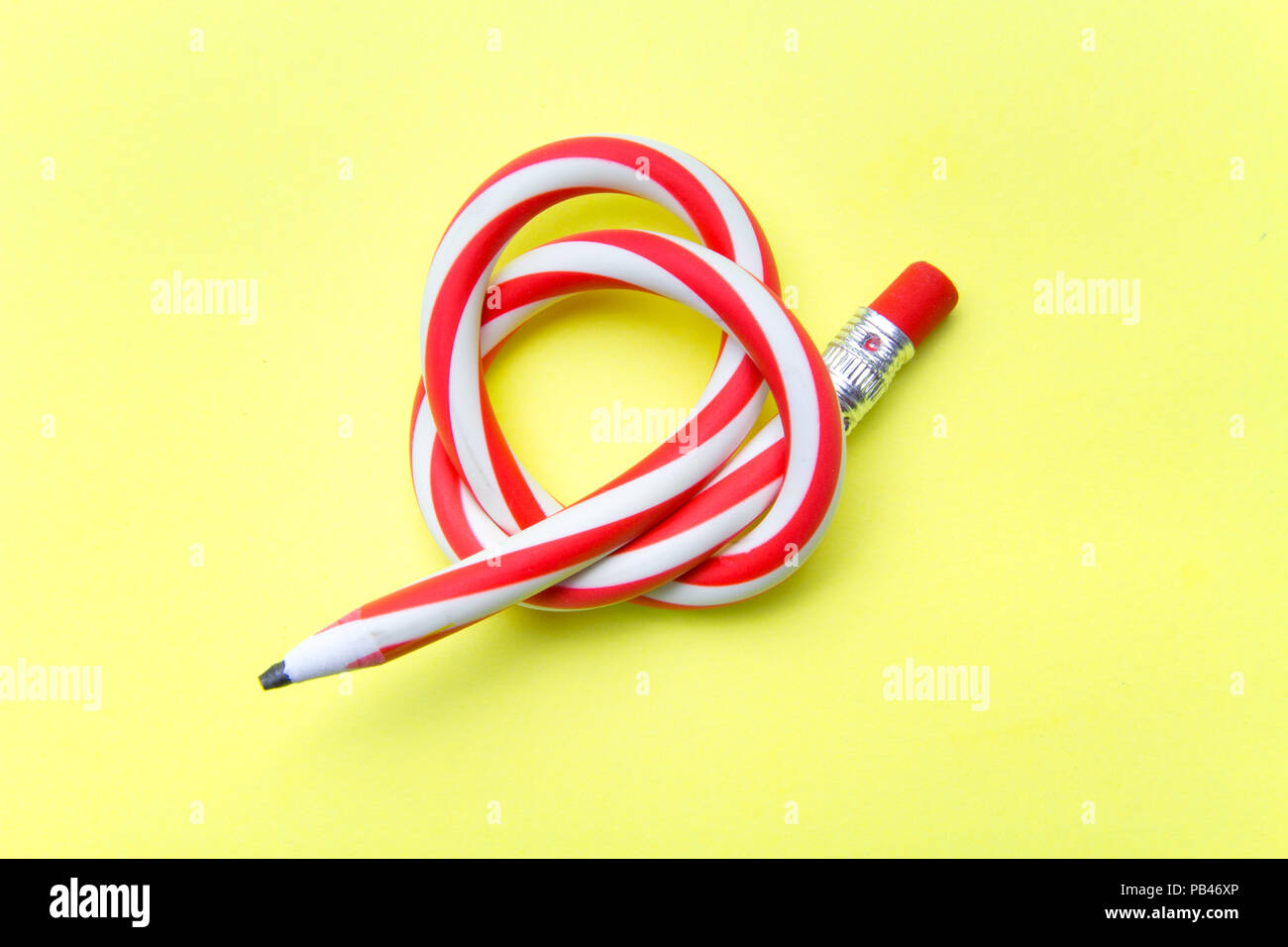 Flexible pencil on a turquoise notebook. Bent pencils two-color Stock Photo  - Alamy