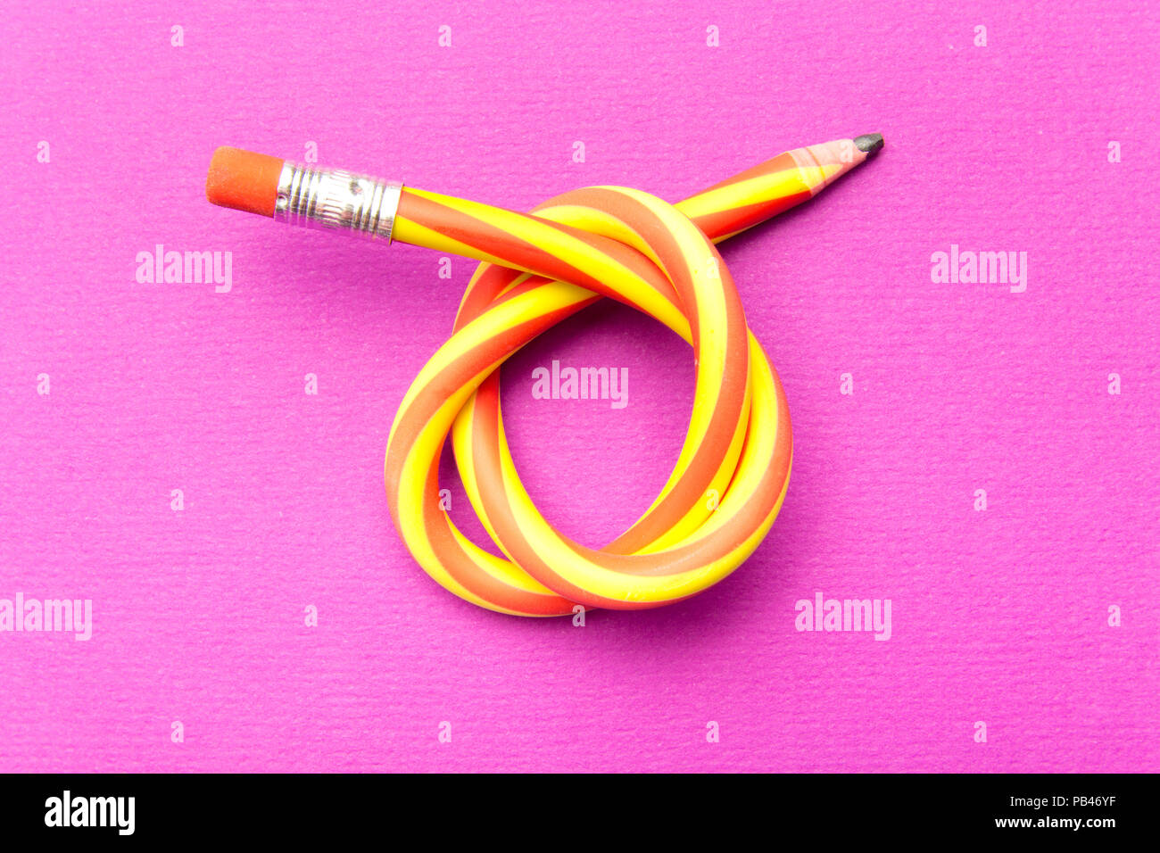 Flexible pencil on a turquoise notebook. Bent pencils two-color Stock Photo  - Alamy