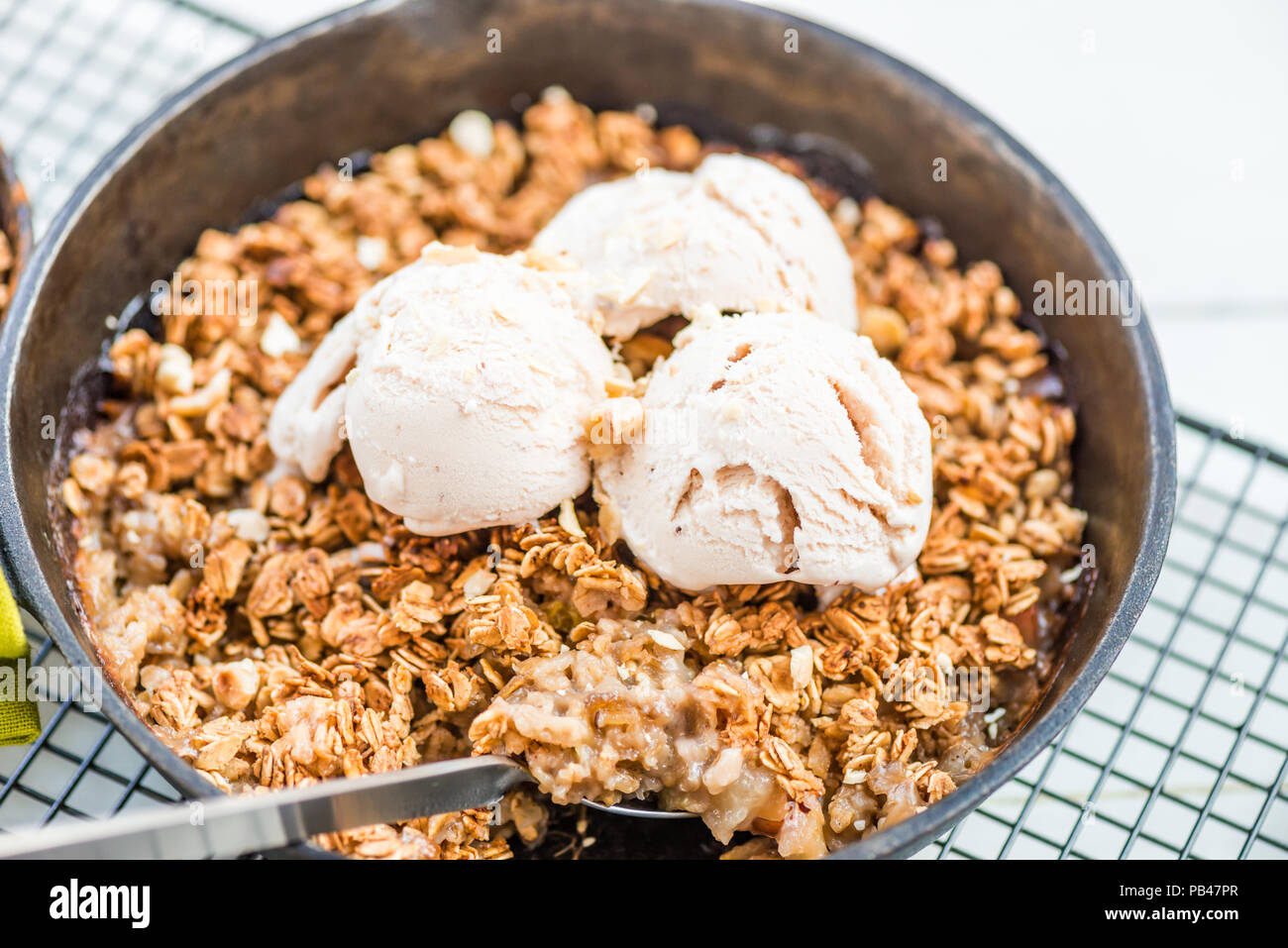Homemade cooked rhubarb and apple crumble with oatmeal and vanilla ice