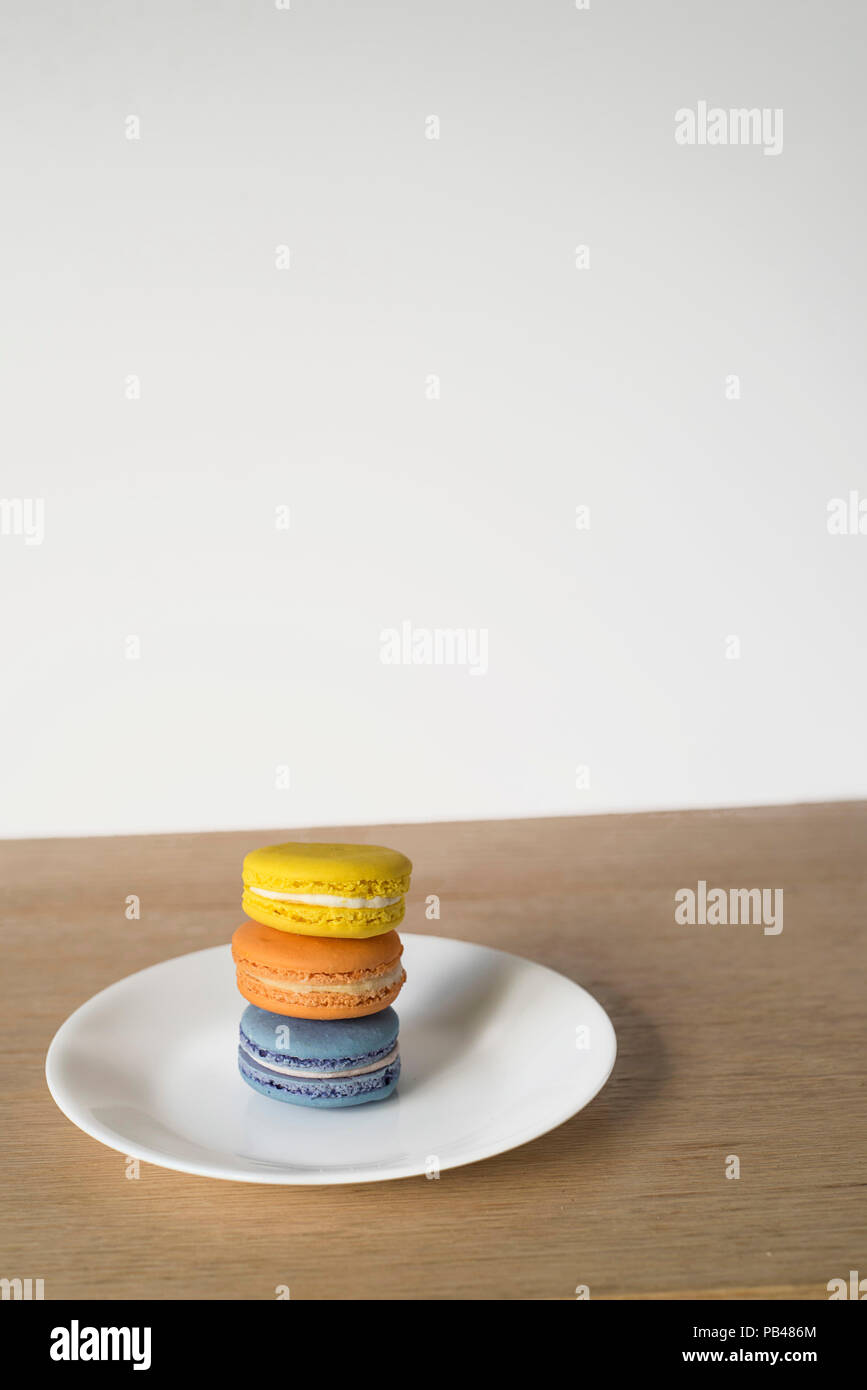 Macarons Set of Three Sitting in Bright Sun on a Minimal Background Stock Photo